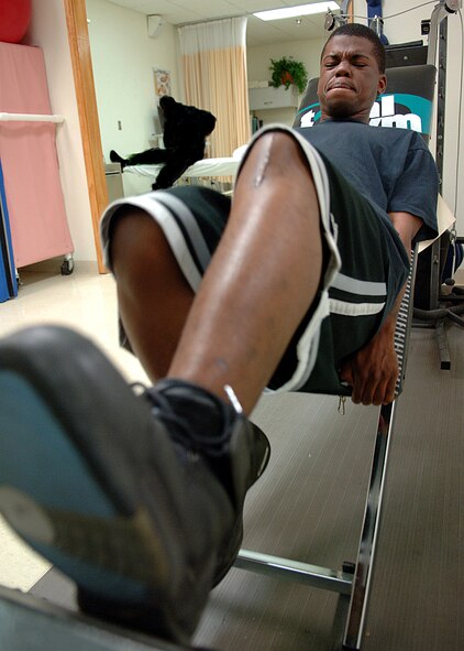 Senior Airman Michael French of the 49th Force Support Squadron performs a knee extension exercise at the physical therapy clinic on Holloman Air Force Base, N.M., June 5.  Airman French jogs lightly and performs stretches while away from physical therapy to help with his rehabilitation.  (U.S. Air Force photo illustration /Airman 1st Class John Strong) 
  