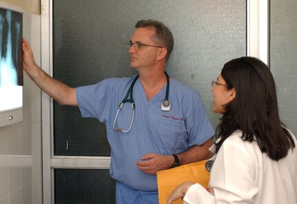 Lt. Col. Steven Romiti, a doctor with the 399th Combat Support Hospital from Pittsburgh, Pa. discusses an x-ray with Honduran medical student Mariana Flores.(Courtesy photo)