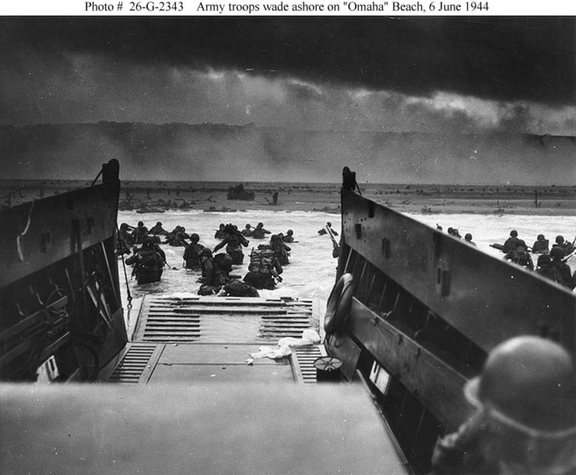 U.S. NATIONAL ARCHIVES -- American soldiers wade through water into Nazi machine-gun fire on the coast of France. Amphibious craft landed 130,000 troops along the five beaches. (courtesy photo)