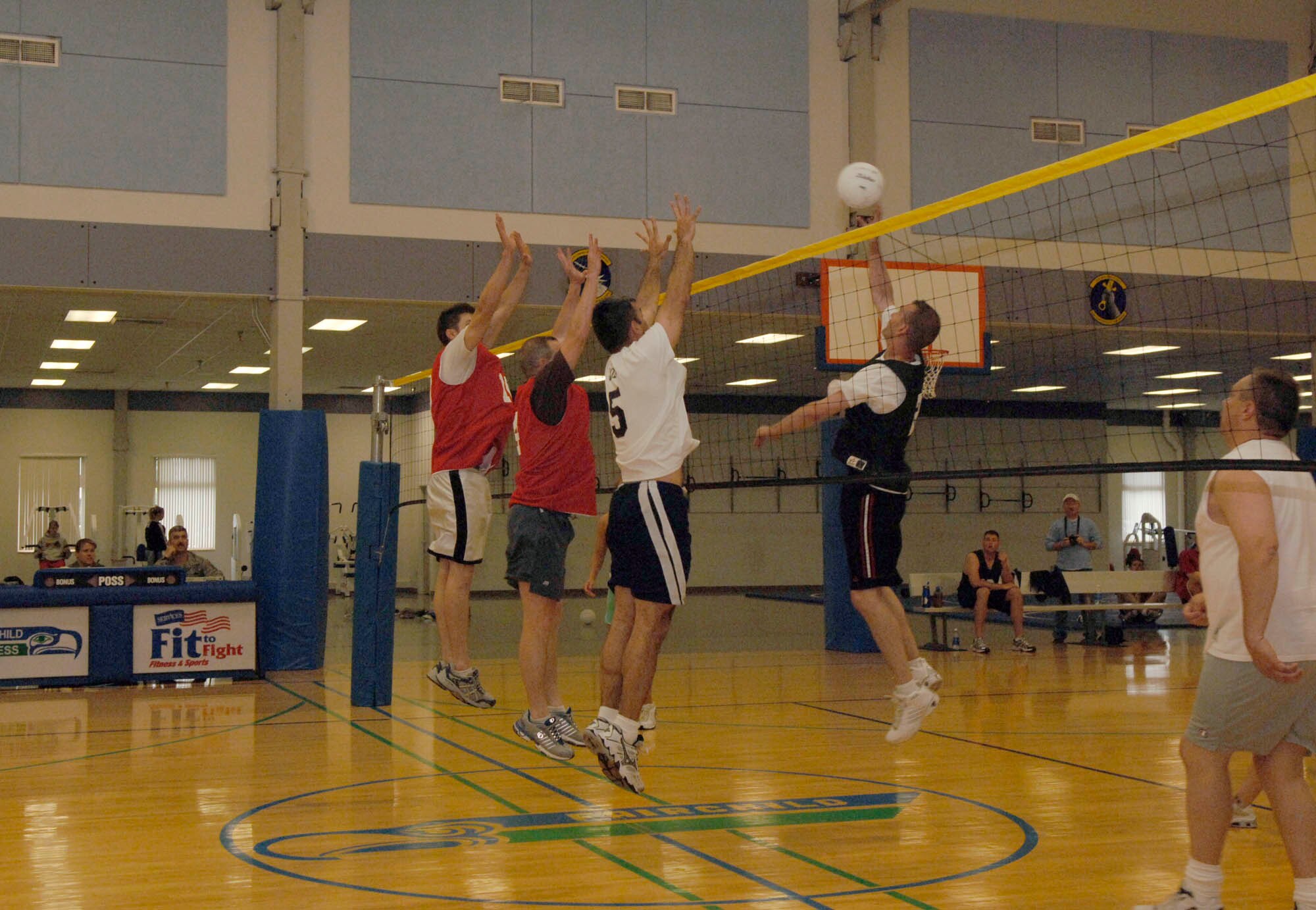 FAIRCHILD AIR FORCE BASE, Wash. – Members of the 336th Training Group volleyball team work together to block a spike from their opponents, the 92nd Operations Group, here June 3. The 336th Training Group continues to uphold their reputation after finishing first for the second year in a row. (U.S. Air Force photo / Airman 1st Class Darlene West)  