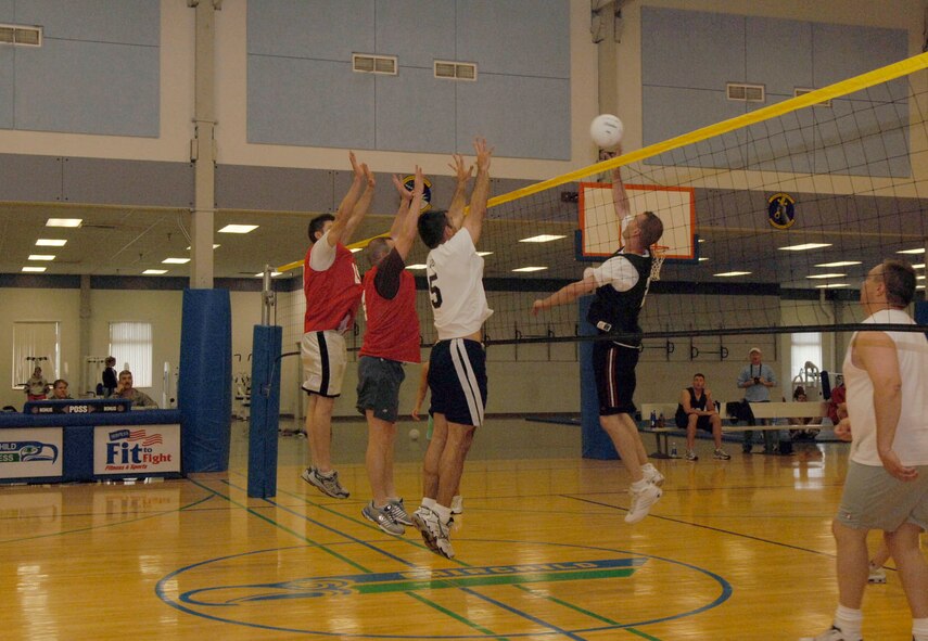 FAIRCHILD AIR FORCE BASE, Wash. – Members of the 336th Training Group volleyball team work together to block a spike from their opponents, the 92nd Operations Group, here June 3. The 336th Training Group continues to uphold their reputation after finishing first for the second year in a row. (U.S. Air Force photo / Airman 1st Class Darlene West)  