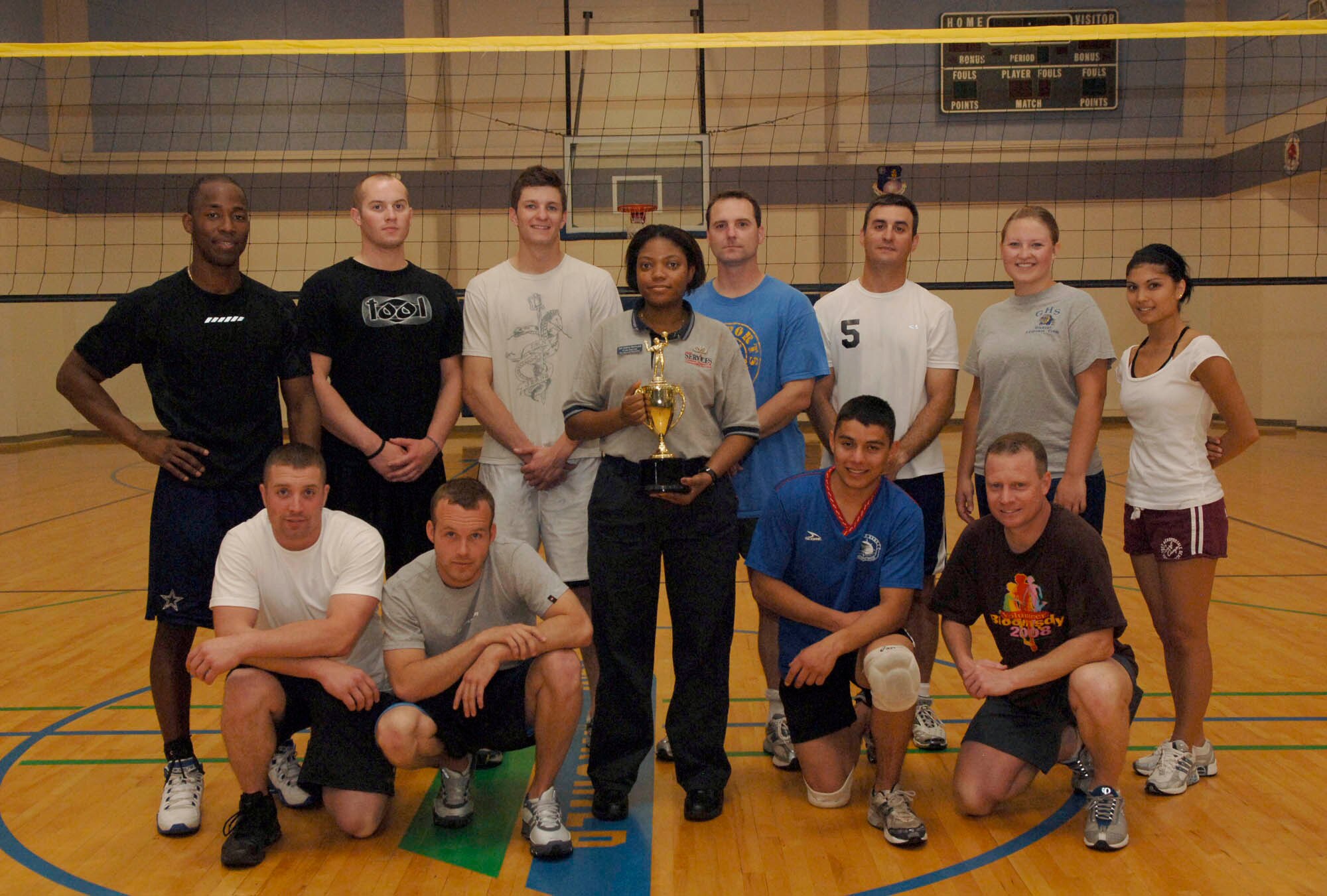 FAIRCHILD AIR FORCE BASE, Wash. – Senior Airman Diana Romulus, 92nd Services Squadron, presents the 336th Training Group volleyball team a trophy after their victory here June 3. The 336th Training Group finished in first place for the second year in a row. (U.S. Air Force photo / Airman 1st Class Darlene West)