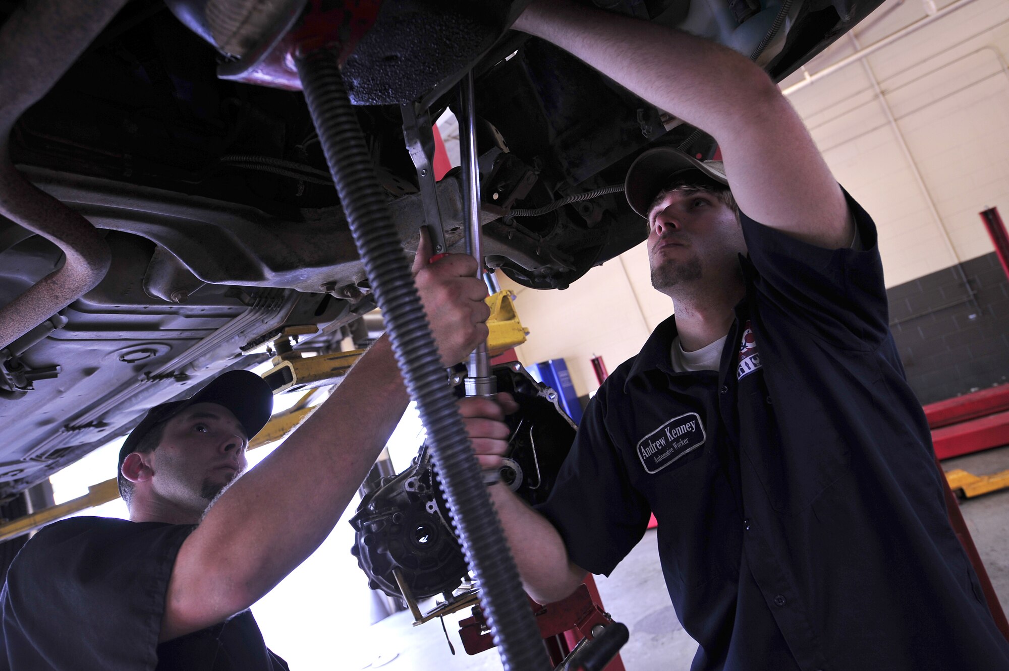 MOODY AIR FORCE BASE, Ga. -- Roger Stanley, 23rd Force Support Squadron Hobby Shop automotive mechanic, assists Andrew Kenney, 23rd Force Support Squadron Hobby Shop automotive worker, while he uses a torque wrench to tighten the bolts on a flywheel here June 5. It is important follow the manufactures specific torque recommendations when working on a vehicle. (U.S. Air Force photo by Senior Airman Elizabeth Rissmiller)