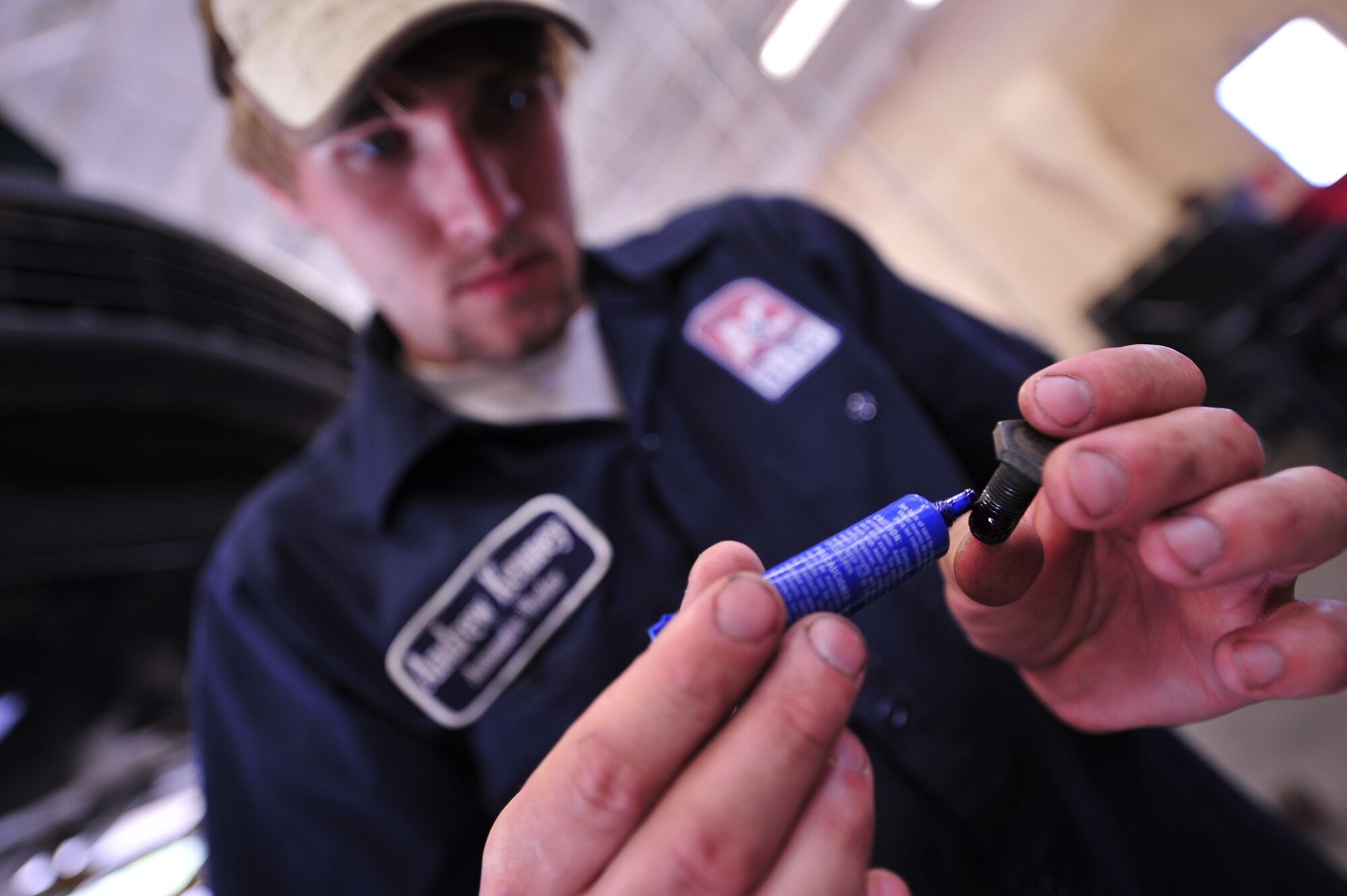 MOODY AIR FORCE BASE, Ga. -- Andrew Kenney, 23rd Force Support Squadron Hobby Shop automotive worker, applies Threadlocker to flywheel bolts here June 5. Mr. Kenney applies the non-permanent adhesive to ensure that the bolt won’t loosen during vibrations and collisions. (U.S. Air Force photo by Senior Airman Elizabeth Rissmiller) 