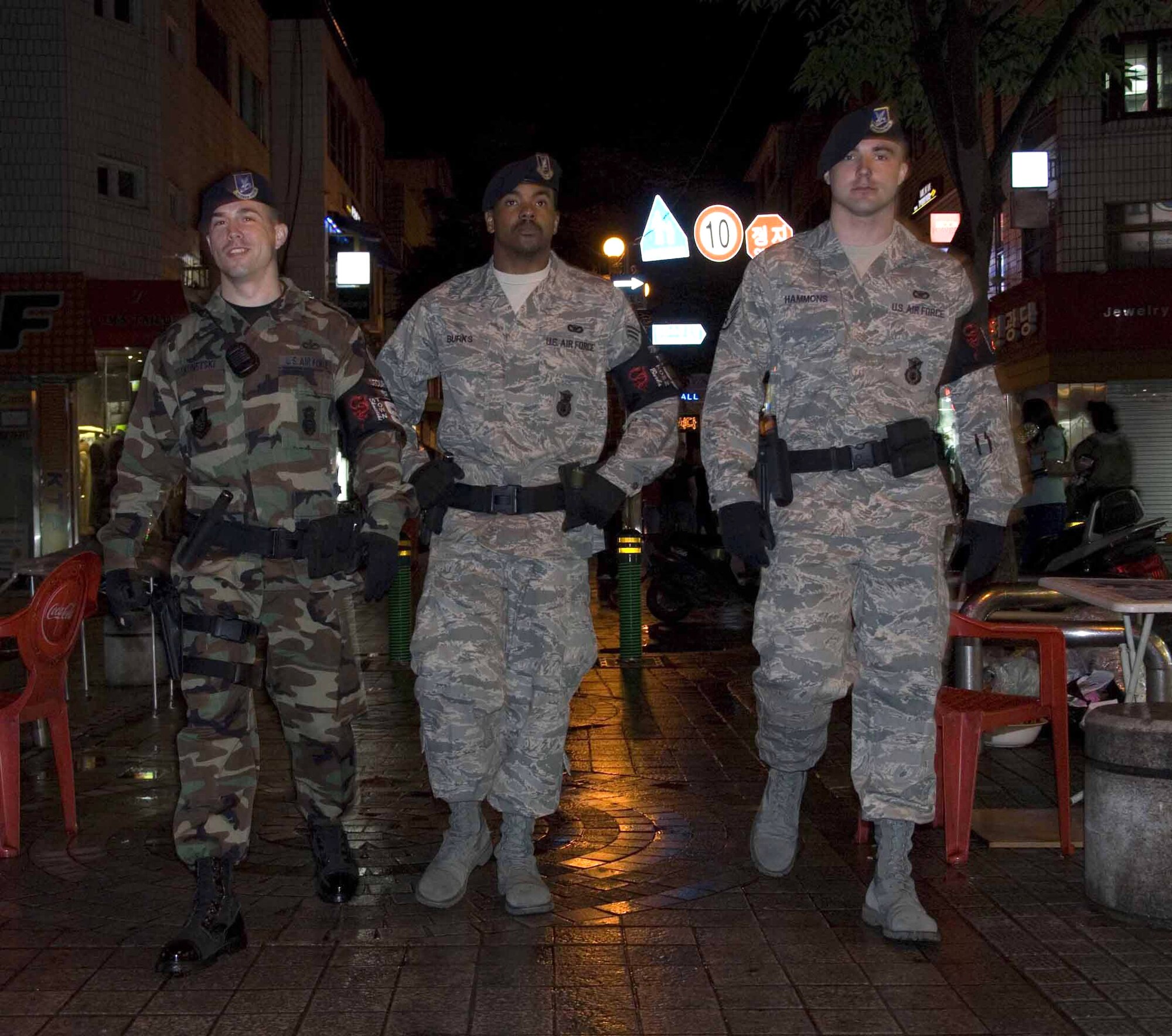 Staff Sgt. Michael Skonetski (left to right), Senior Airman Michael Burks and Staff Sgt. Erick Hammons patrol the downtown area June 4 outside of Osan Air Base, South Korea. The Airmen were among the first responders after a fire engulfed a local restaurant May 30. They helped evacuate patrons and provided crowd control until local authorities arrived. The three are 51st Security Forces Squadron's town patrol members. (U.S. Air Force photo/Master Sgt. Marlin Zimmerman) 
