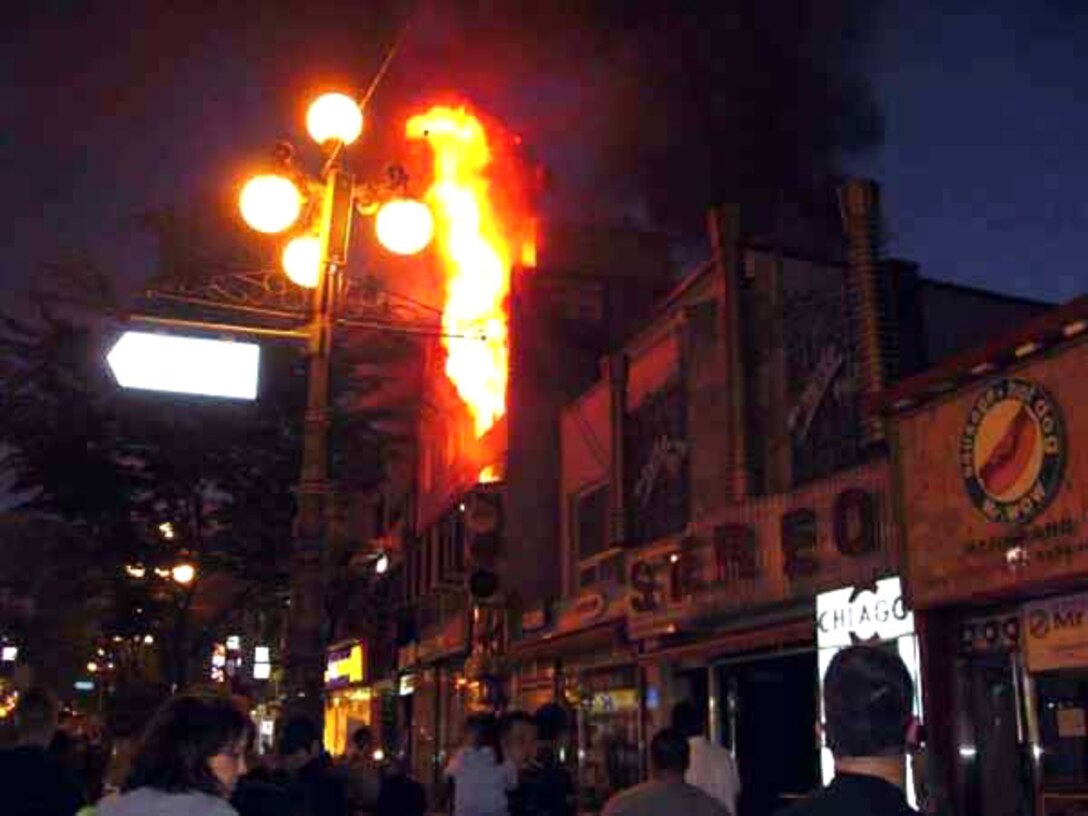 A fire engulfs a restaurant May 30 outside of Osan Air Base, South Korea. Members of the 51st Security Forces Squadron town patrol section were among the first responders and helped evacuate patrons and provide crowd control until local authorities arrived. (Courtesy photo) 