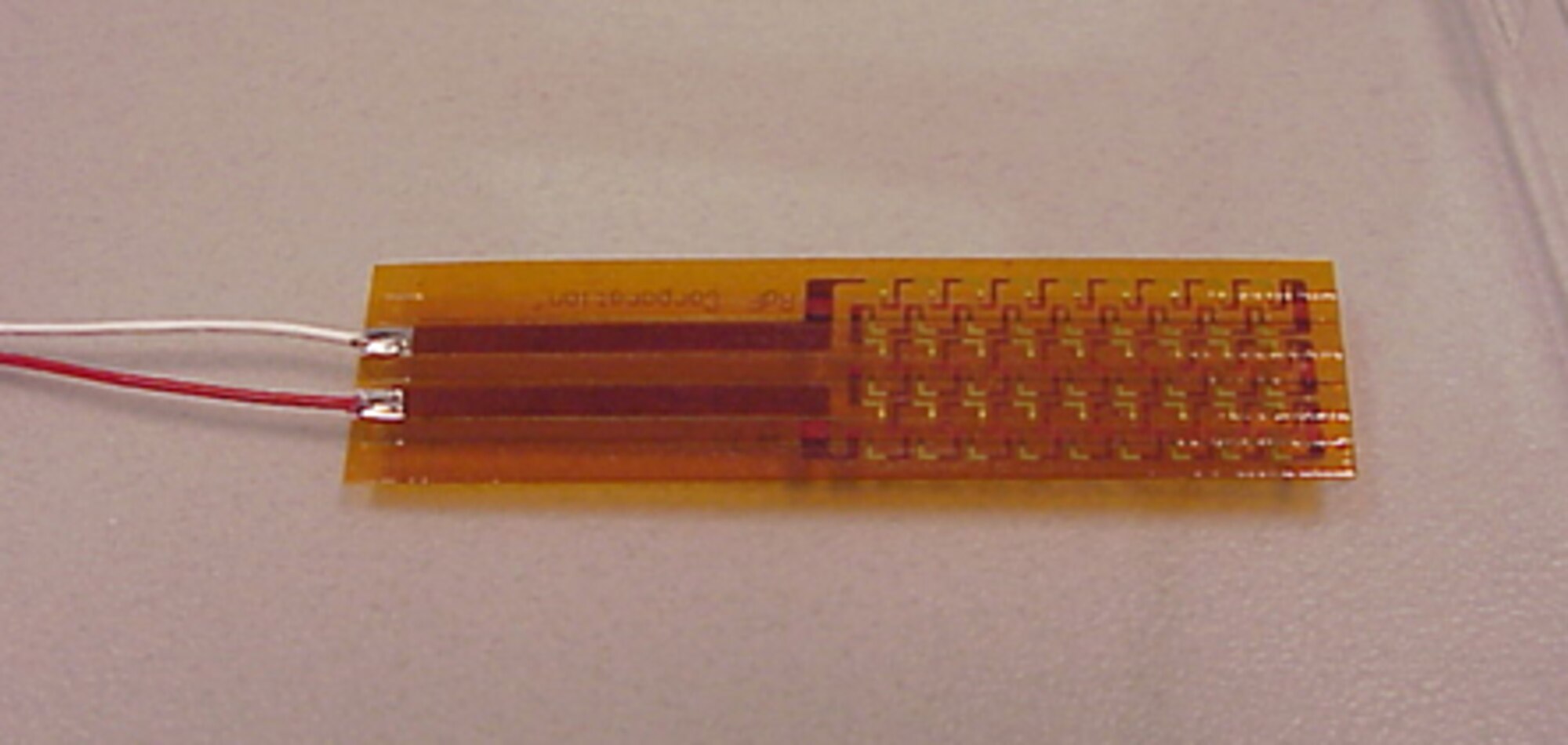 A heat flux sensor is shown before being attached to a copper plate.  Pictures are courtesy of Sensortek Inc. and ATEC Inc.