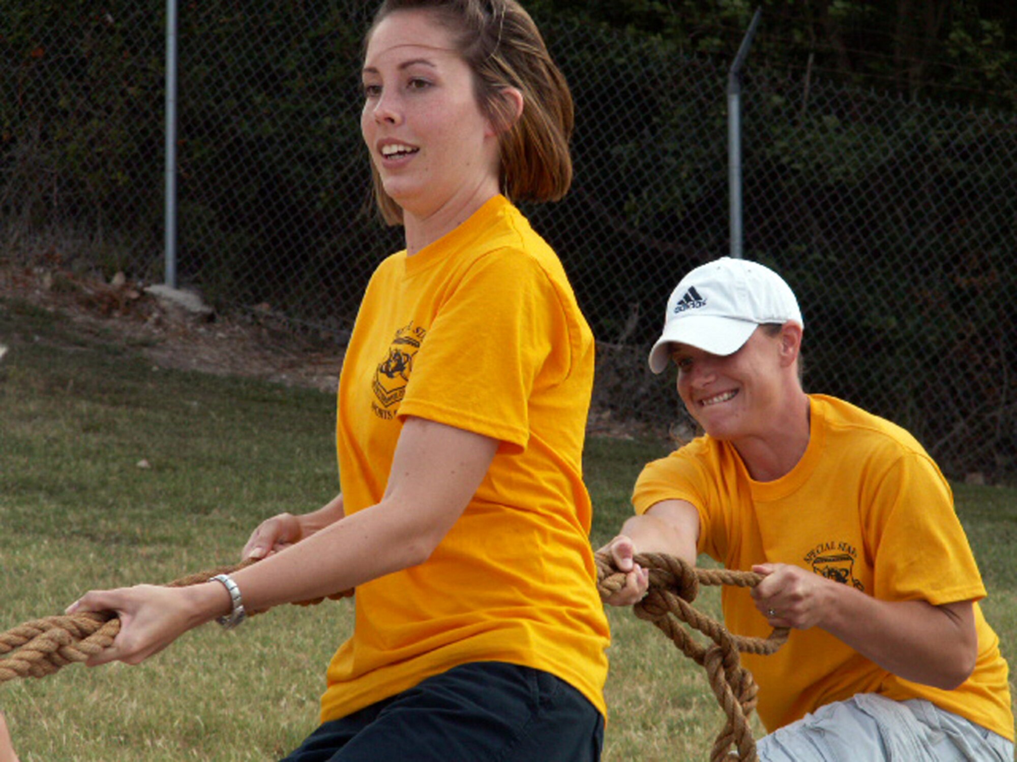 Senior Airman Brittney Nanchy (left) and Staff Sgt. Sunshine Scarborough dig their heels in during a muscle-straining round of Tug-o-War during the Air Force Personnel Center's sports day here at Randolph Air Force Base, Texas, June 4. Both Airmen are personnelists on the commander's support staff. Their directorate, Special Staff, won third place overall in the women's division. (US Air Force photo/Master Sgt. Kat Bailey) 