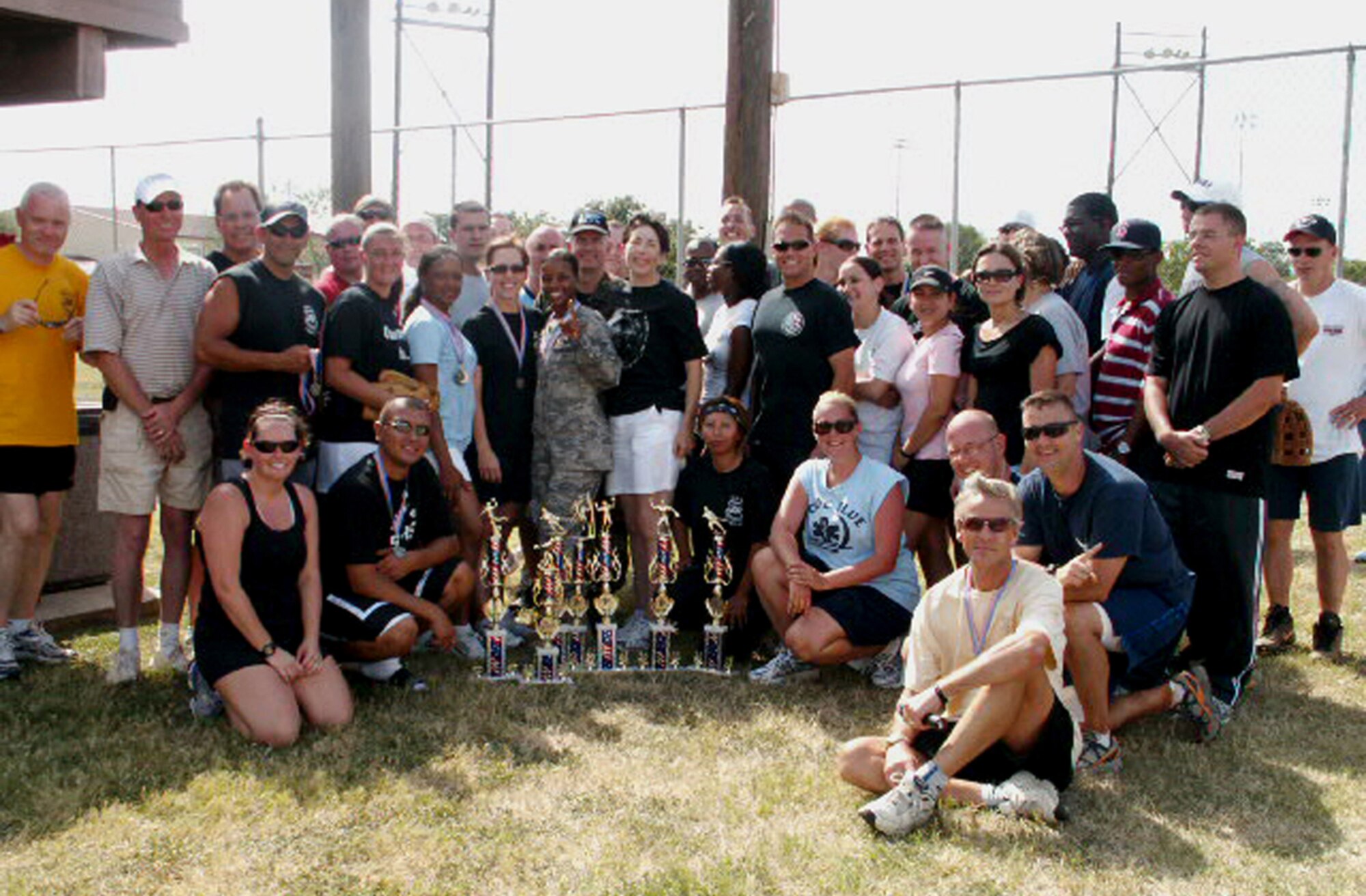 Chief Master Sgt. Andy Kaiser, Air Force Personnel Center command chief (far left) and Rob Thomas, AFPC executive director (seated, right front), pose with AFPC's sports day champion directorate, assignments. AFPC held the sports day here at Randolph Air Force Base, Texas, to boost esprit de corps and camaraderie. (US Air Force photo/Master Sgt. Kat Bailey) 