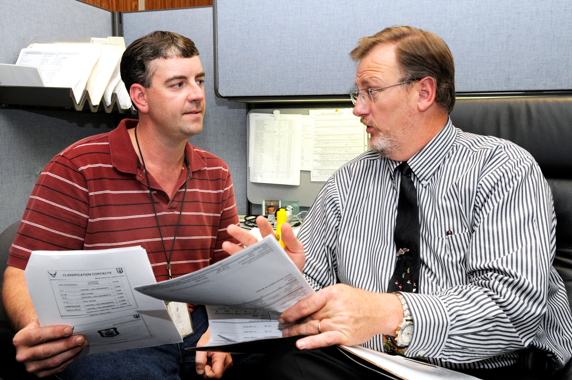 Shane Parten, a painter with the 402 AMXG, is counseled by Phil House, human resource specialist, about his civil service career brief. U. S. Air Force photo by Sue Sapp