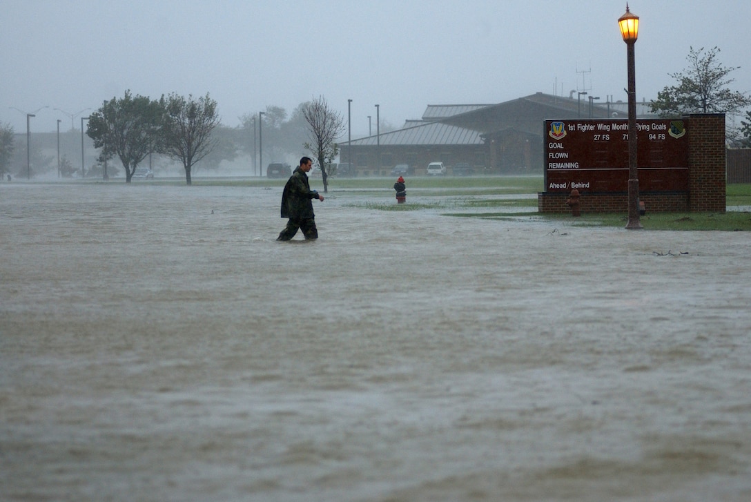 LANGLEY AIR FORCE BASE, Va. -- Videographer Staff Sgt. Jason Smith walks toward the 1st Fighter Wing headquarters building during Hurricane Isabel Sept. 18, 2003. Isabel left 32 fatalities and $1.9 billion in damages throughout Virginia. (U.S. Air Force photo/Tech. Sgt. Ben Bloker)