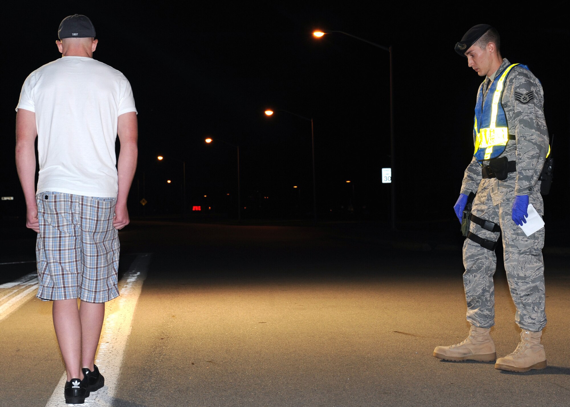 Staff Sergeant Andrew Rounds, 4th Security Forces Squadron, conducts a field sobriety test on an individual inspected of being under the influence of alcohol while under the age of 21, Seymour Johnson AFB, N.C. May 31, 2008.  The inspection is conducted randomly throughout the year by order of the Installation Commander.
(US Air Force photo by Airman First Class Salma Nebot)(released)
