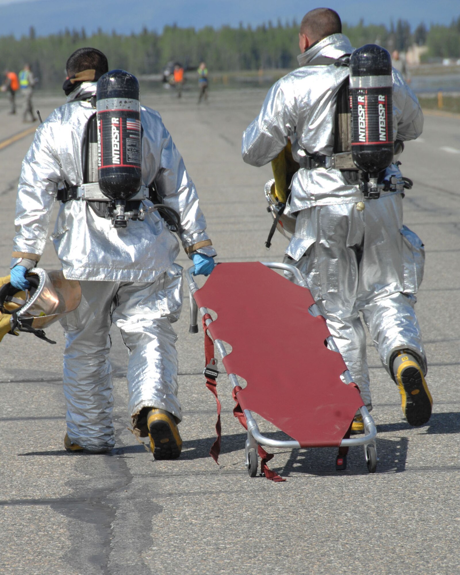 Firefighters with the 354th Civil Engineer Squadron respond to a simulated aircraft accident to assist Airmen and Community Members on the flightline during the Emergency Management Exercise here May 30, 2008. The EME prepares emergency teams for real world situations.  (U.S. Air Force photo/Staff Sgt. Tia Schroeder)