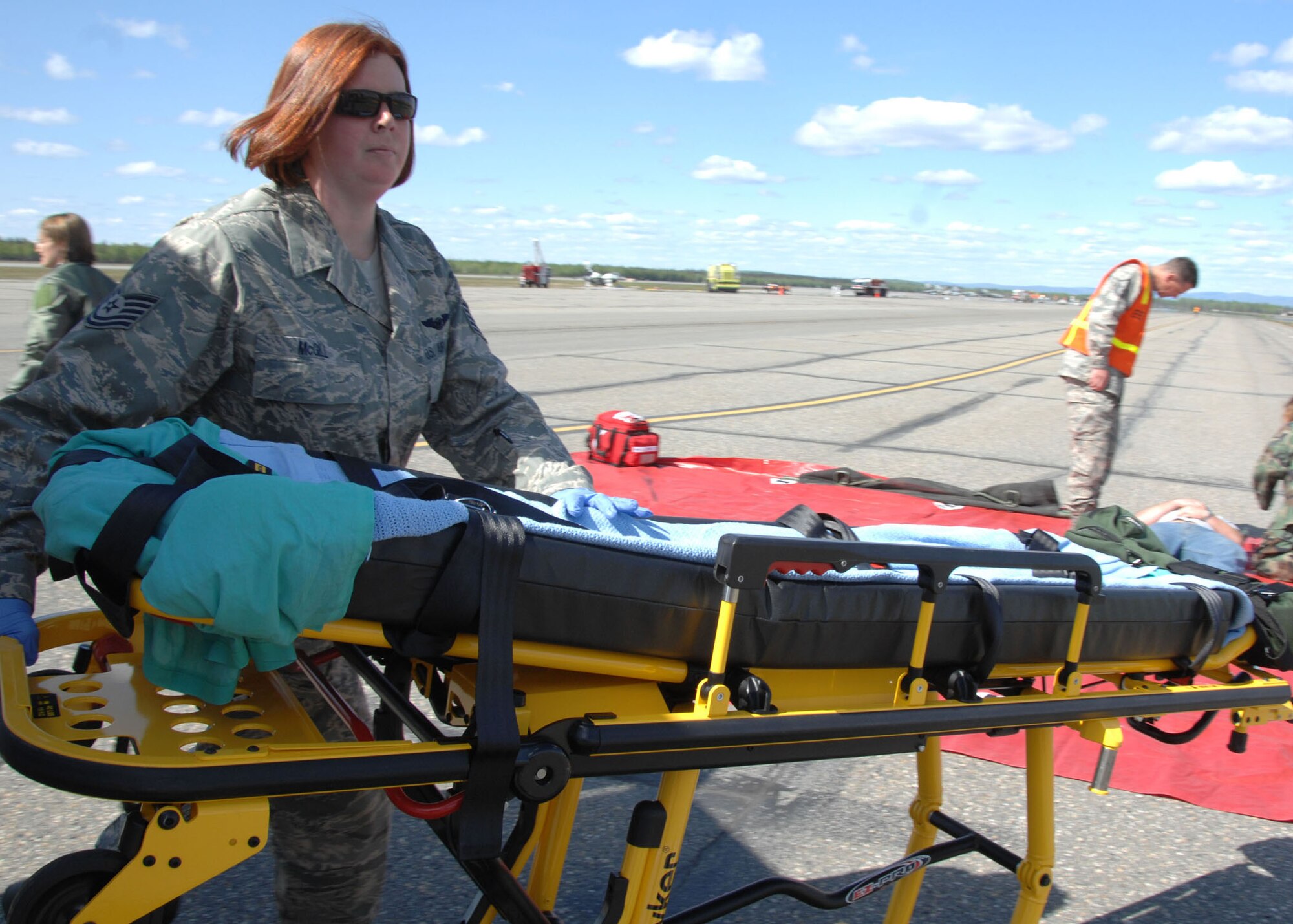 Technical Sgt. Dena McGill responds to a simulated aircraft accident to assist Airmen and Community Members on the flightline during the Emergency Management Exercise here May 30, 2008. The EME prepares emergency teams for real world situations. Sergeant McGill is an emergency medical services technician, 354th Medical Support Squadron, Eielson AFB, Alaska. (U.S. Air
Force photo/Staff Sgt. Tia Schroeder)