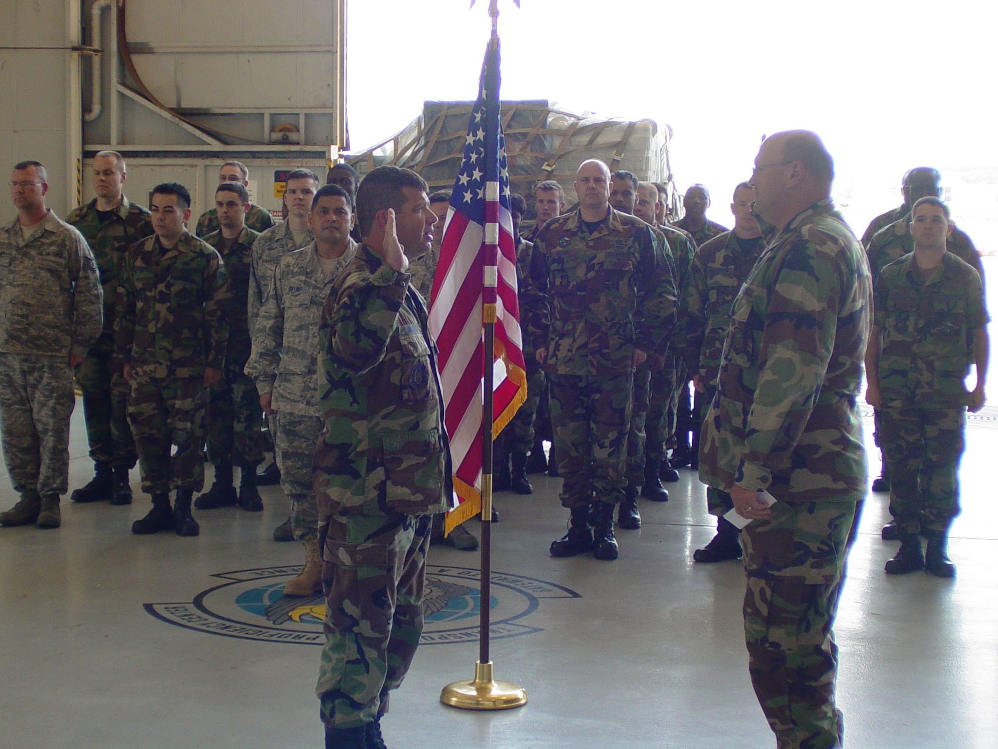 On June 4, Lt. Col. Douglas L. Batson, 22nd Air Force chief of Logistics Readiness, performed the reenlistment ceremony of Tech. Sgt. Allen D. Drake, Transportation Proficiency Center Instructor, in front of TPC staff and students. (Air Force photo/Master Sgt. Louis Agredo).            