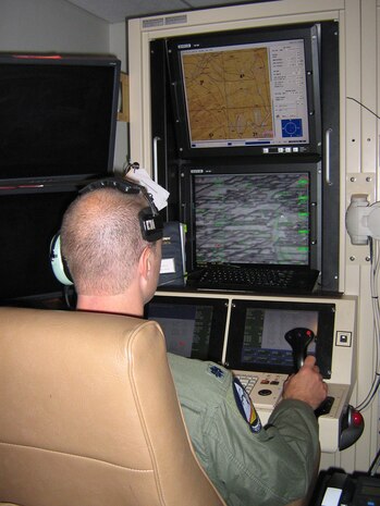 CREECH AIR FORCE BASE, Nev.—Lt. Col. Jon Greene, commander of the 42nd Attack Squadron, takes the lead as the pilot of an MQ-9 Reaper mission in the Reaper  ground control station at Creech AFB, while displaying the mission live to visiting journalists from the United Kingdom and the Las Vegas Valley.  This was the first time ever that the Coalition Forces has had two squadron commanders flying together for an MQ-9 mission—and showing the mission live to non-military personnel.