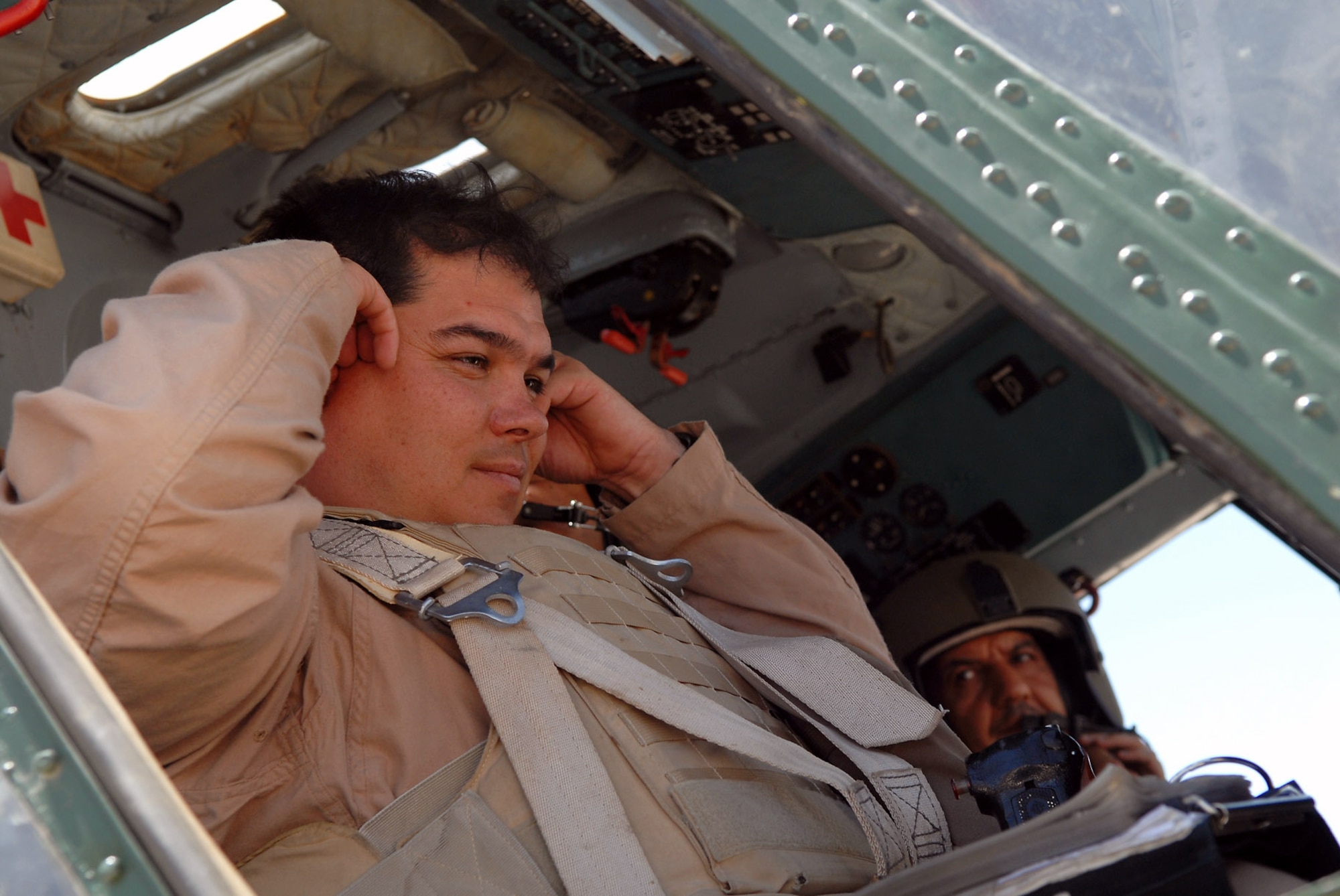 Maj. Jiro McCoy prepares to take off on a training mission May 29 over Camp Taji, Iraq. The major is a member of the 770th Air Expeditionary Advisory Squadron, which is part of the Coalition Air Force Transition Team in Iraq. The unit's mission is to assess, advise, educate, train and assist the Iraqi air force helicopter wing personnel on providing counter insurgency operations via air support. Major McCoy is deployed from Fort Rucker, Ala. and has been deployed for more than 18 months. (U.S. Air Force photo/Senior Airman Julianne Showalter) 