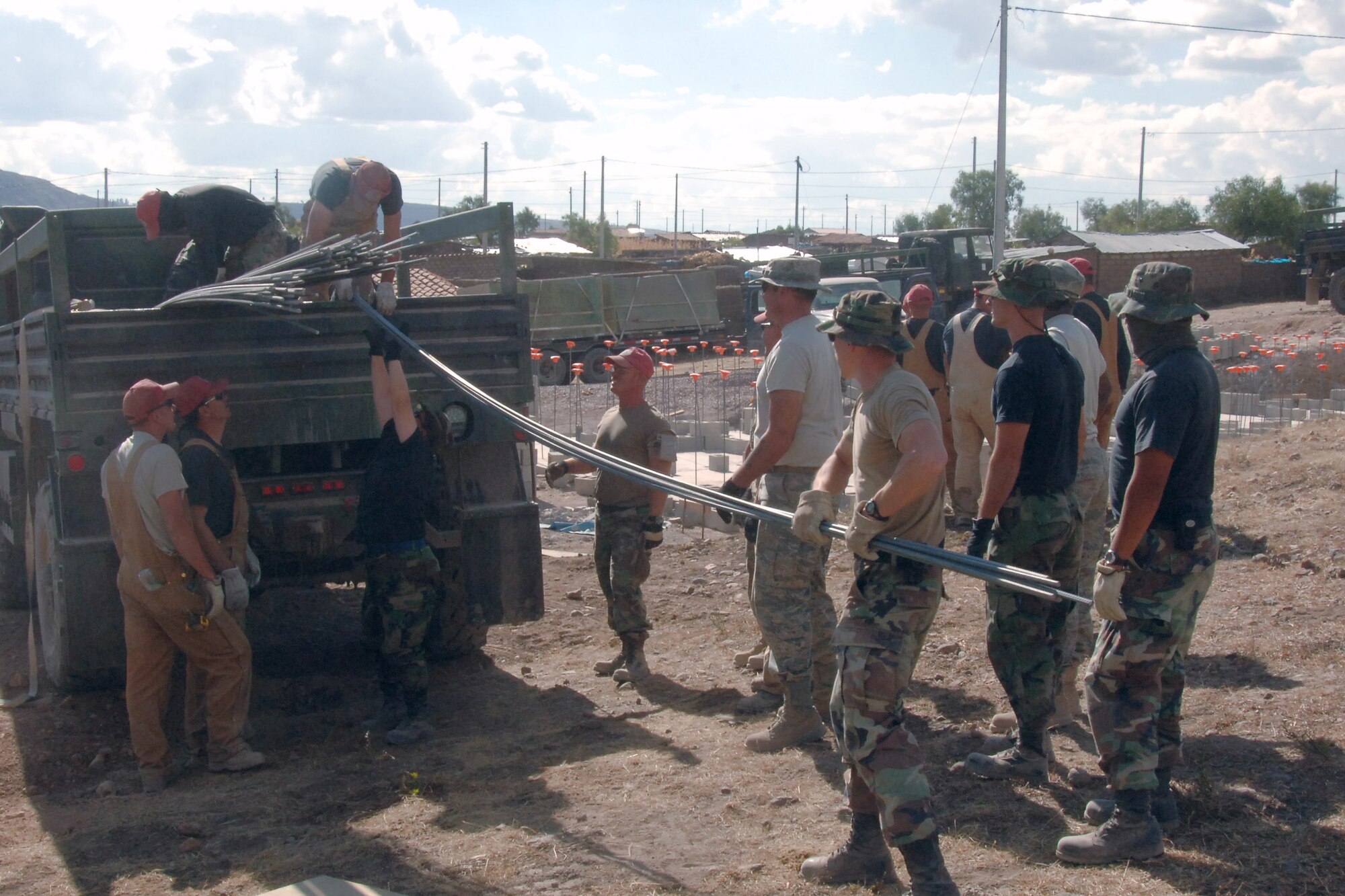 Airmen assigned to Task Force New Horizon-Peru 2008 unload rebar to begin construction of a clinic in Yanama, Peru. The construction is in support of New Horizons Peru 2008, a humanitarian event that benefits thousands of Peruvians. Nearly 300 members came together to provide Peruvians with new schools, clinics and water wells. (U.S. Air Force photo/Tech. Sgt. Kerry Jackson)