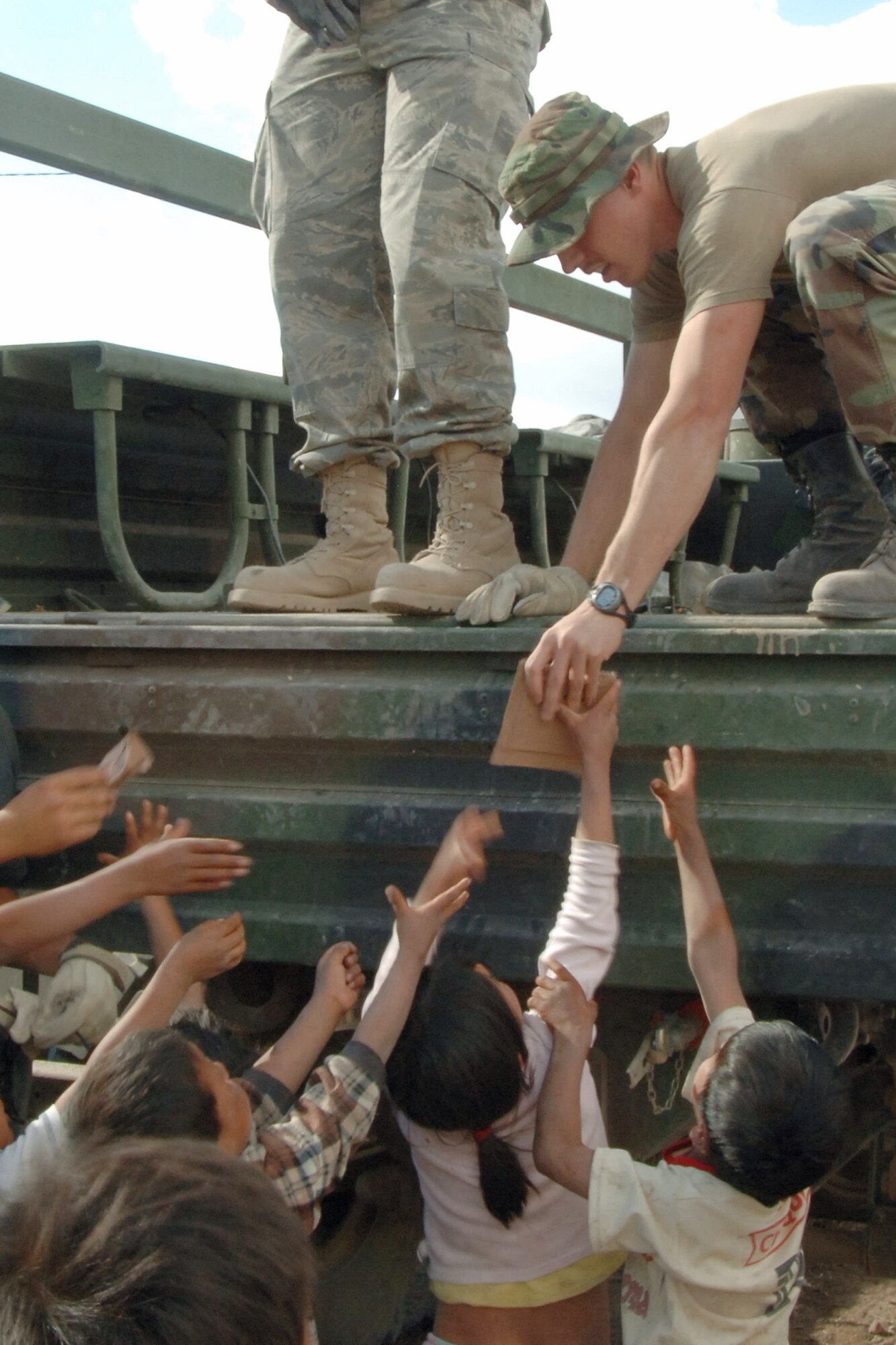 Staff Sgt. Brandt Higley and other Airmen greet a group of Peruvian children June 3 before beginning construction of a clinic in Yanama, Peru, in support of New Horizons Peru 2008, a humanitarian event that benefits thousands of Peruvians. Nearly 300 members from the U.S. Air Force, Army, Marines and Navy came together to provide Peruvians with new schools, clinics and water wells. The Airmen are assigned to Task Force New Horizon-Peru 2008. (U.S. Air Force photo/1st Lt. Mary Pekas) 