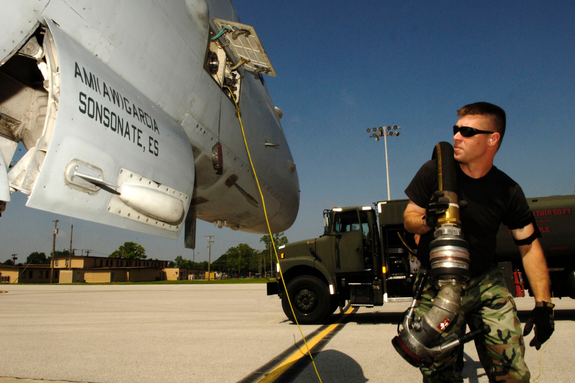 SCOTT AIR FORCE BASE, Ill. -- Staff Sgt. Ed Mueller, 375th Logistics Readiness Squadron, Fuels Management Flight, distribution operator, pulls hose from his fuel truck to a waiting fighter jets that stopped at Scott last week.
(US Air Force photo/ Airman First Class Megan Gilliland)

