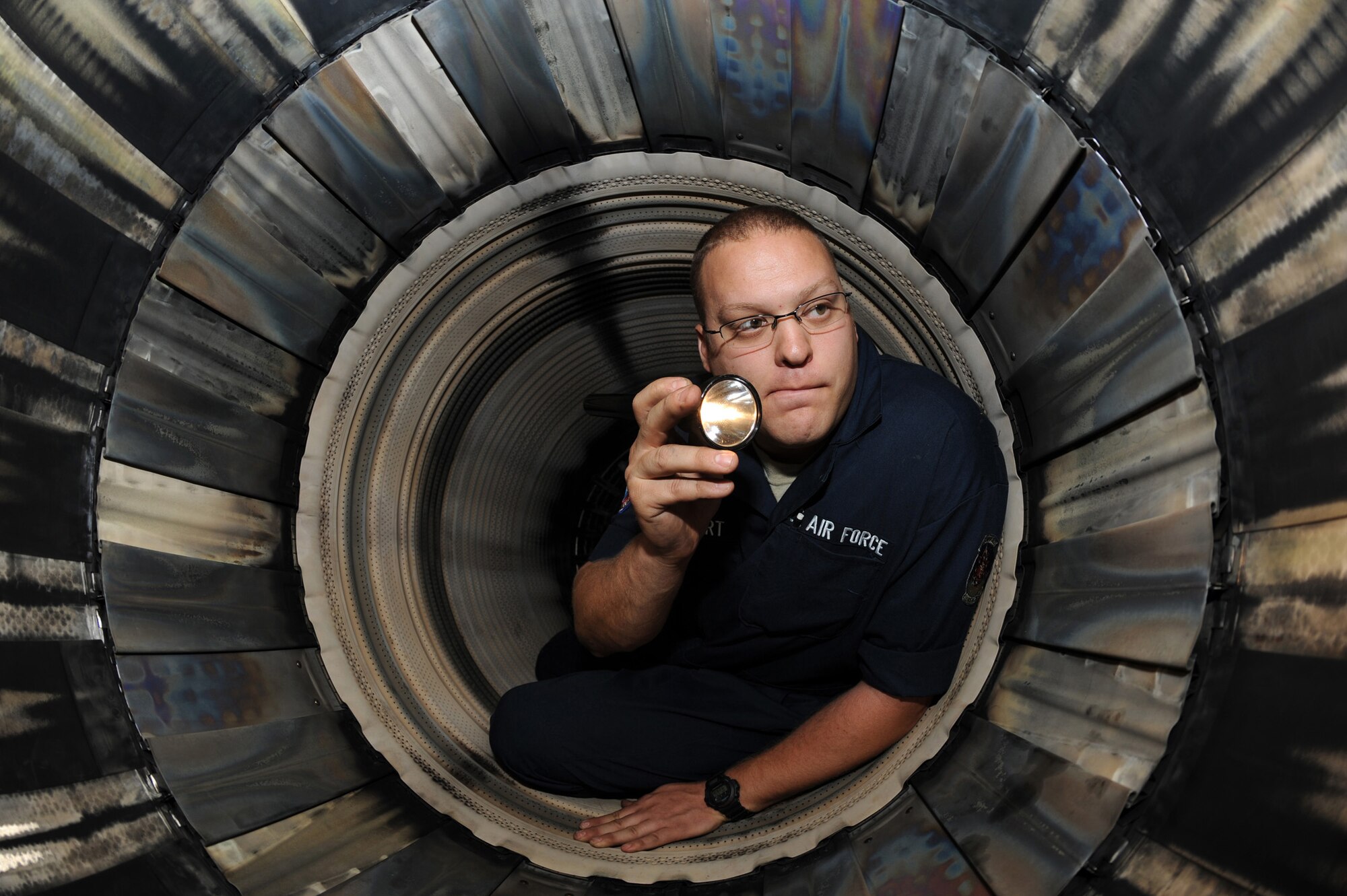 Staff Sergeant Robert Stewart, an aerospace propulsion specialist, 4th Component Maintenance Squadron, inspects the convergent seal and liner of the augmenter on an uninstalled Pratt and Whitney jet engine, Seymour Johnson AFB, N.C. May 21, 2008.  SSgt Stewart is responsible for inspecting the fans inside the augmenter.   (US Air Force photo by Airman First Class Salma Nebot)(Released)