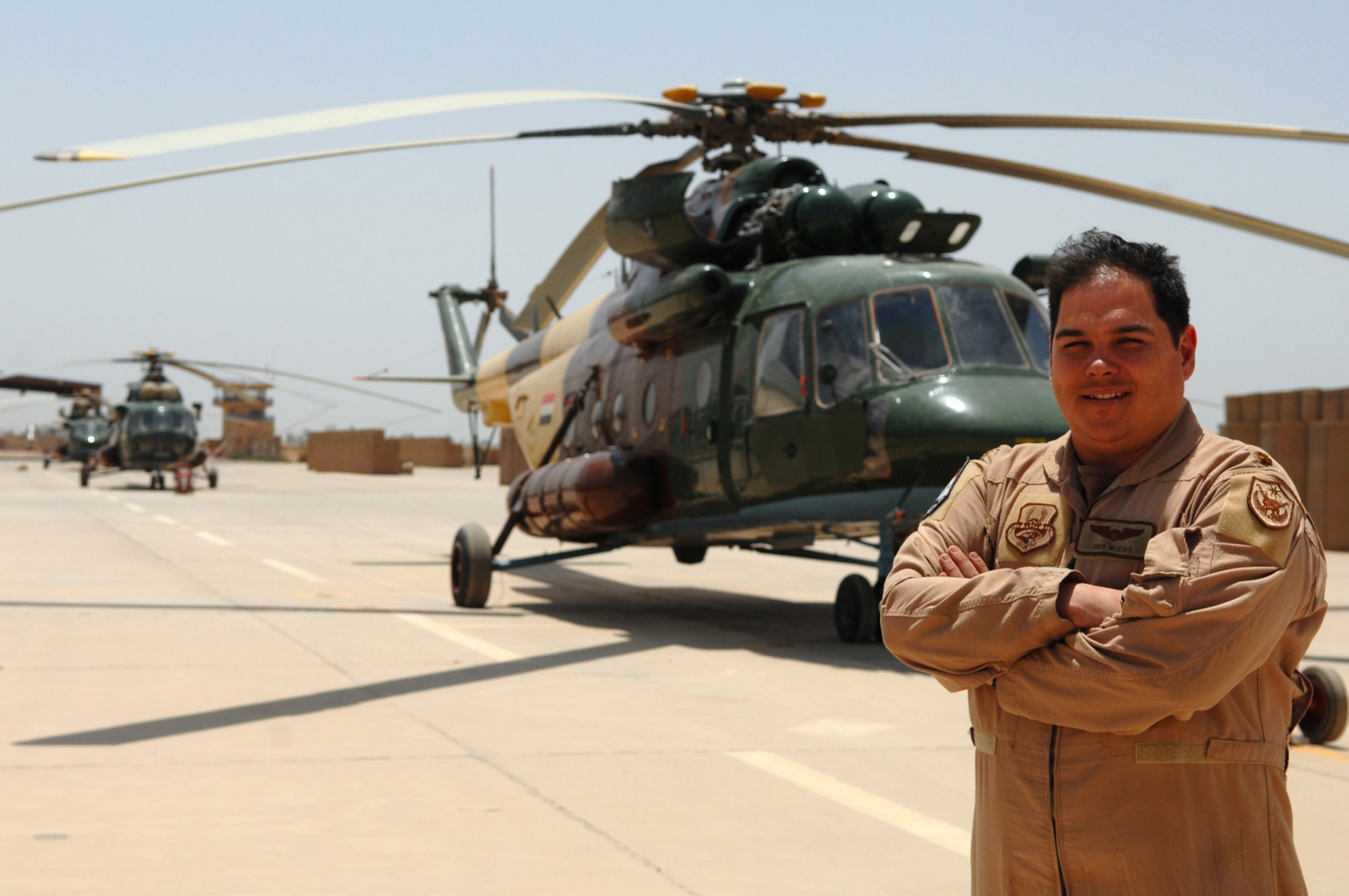 CAMP TAJI, Iraq -- Maj. Jiro McCoy, 770th Air Expeditionary Advisory Squadron,  Mi-17 [multi-role helicopter] commander of advisers, stands near the helicopter he trained Iraqis on during his 18-month deployment here. Major McCoy voluntarily extended his deployment by 12 months in order to assist the Iraqi air force in the tactical employment of the rotary wing being set up at Taji Base. Major McCoy is deployed from Fort Rucker, Ala. (U.S. Air Force photo/ Senior Airman Julianne Showalter)