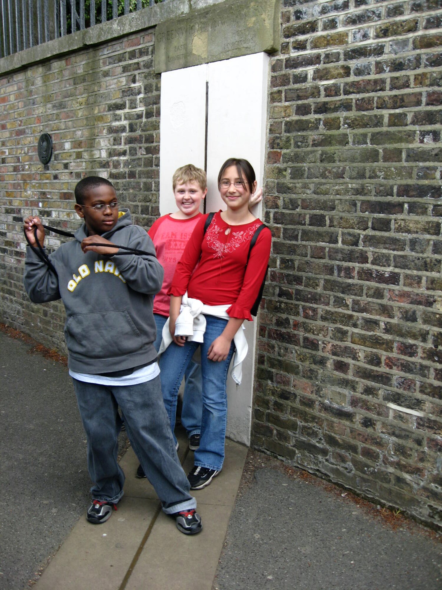 Clarissa Wood, Kevin Jones and Caleb Wilson stand on both the Eastern and Western Hemispheres May 22 in Greenwich, England. Fifth-grade students from the Liberty Intermediate School at RAF Lakenheath, England took a field trip to Greenwich and visited the National Meritime Museum, the Naval Observatory and the Queen's House. (U.S. Air Force photo by Senior Master Sgt. Thomas Wood)