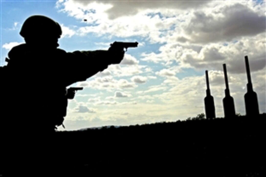 U.S. Marine Lance Cpl. Shae Wheeler practices shooting targets with a pistol at Marine Corps Air Ground Combat Center, Twentynine Palms, Calif., May 24, 2008. Wheeler, assigned to 1st Reconnaissance Battalion, is working through Mojave Viper, a Marine training cycle to prepare infantry units for combat.