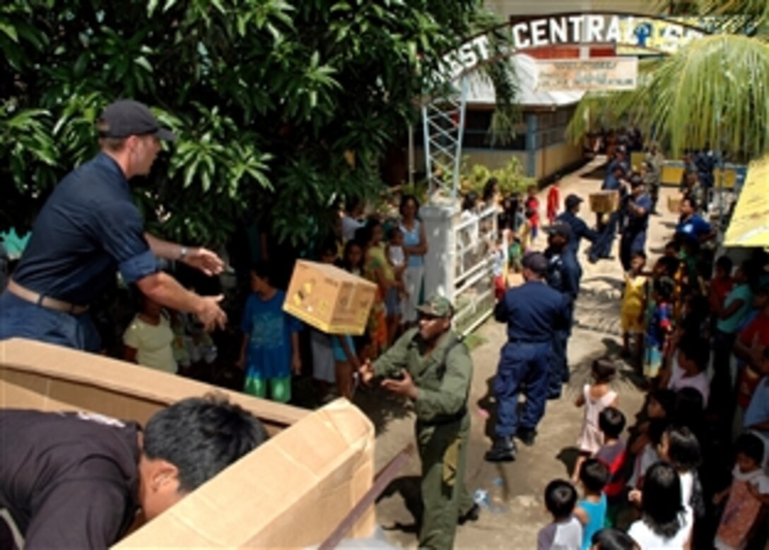 U.S. Navy seamen move cases of basic home personal supplies for distribution to villagers in the Phillipines as part of Cooperation Afloat Readiness and Training (CARAT) 2008, June 2, 2008. Philippine and U.S. maritime forces are supporting a variety of humanitarian and at-sea activities during the annual series of  bilateral maritime training exercises.