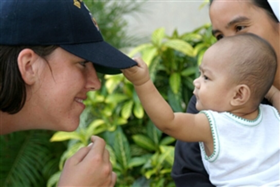 U.S. Navy Ensign Elizabeth Burnett plays with a child during a community project at the Bihay Ni Nanay children's center in Puerto Princesa as part of Cooperation Afloat Readiness and Training, Philippines, June 2, 2008.