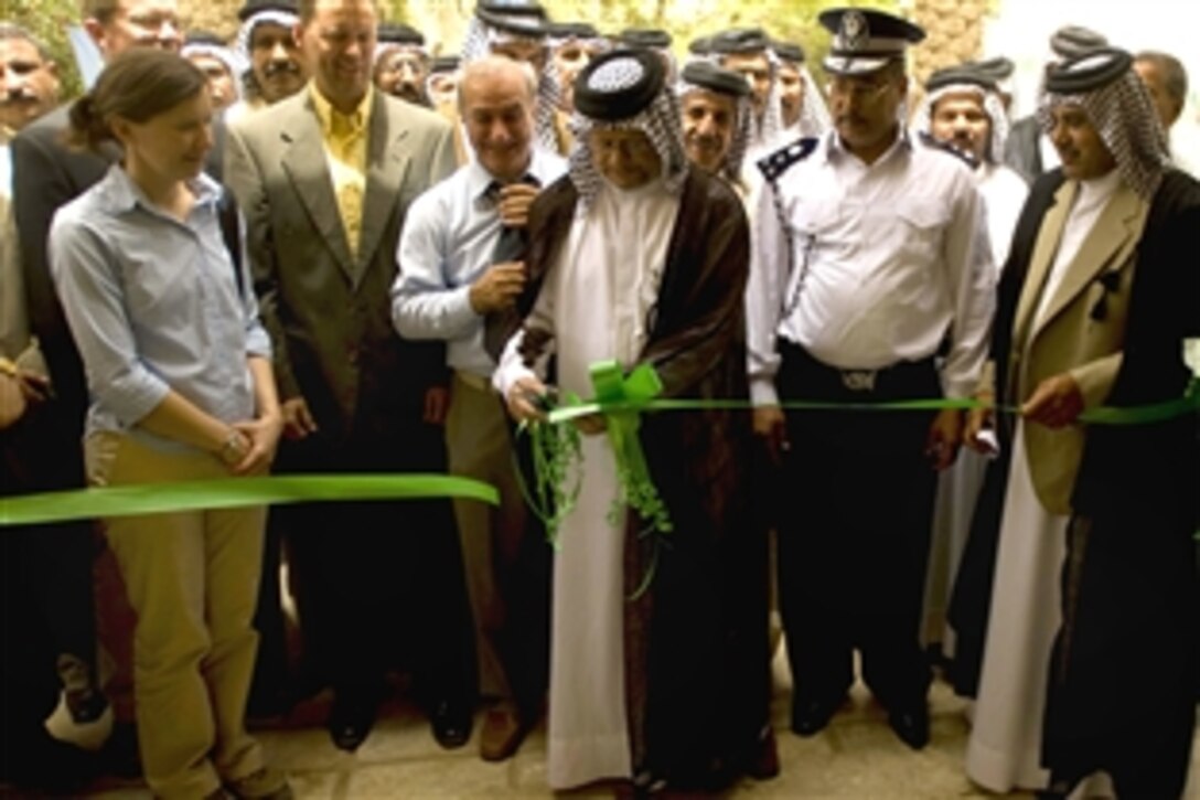 Visitors wait outside Wasit province's Agricultural Union headquarters for the ribbon cutting ceremony that would mark the grand re-opening of the center in al-Kut, Iraq, June 2.

