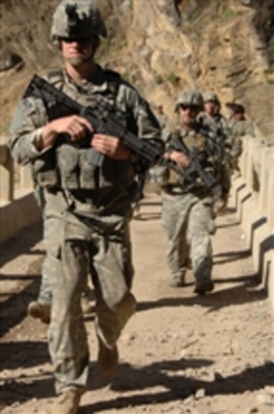 U.S. Army soldiers assigned to Headquarters Troop, 1/91 Cavalry, 173rd Airborne Brigade Combat Team, armed with 5.56 mm M-4 carbines, conduct a security patrol along with Afghanistan national army soldiers into the villages surrounding the Gawerdesh Bridge as U.S. forces reconstruct a border checkpoint in the Nuristan Province of Afghanistan during Operation Mountain Highway 2 on April 27, 2008.  The checkpoint was destroyed one year ago by anti-coalition forces.   