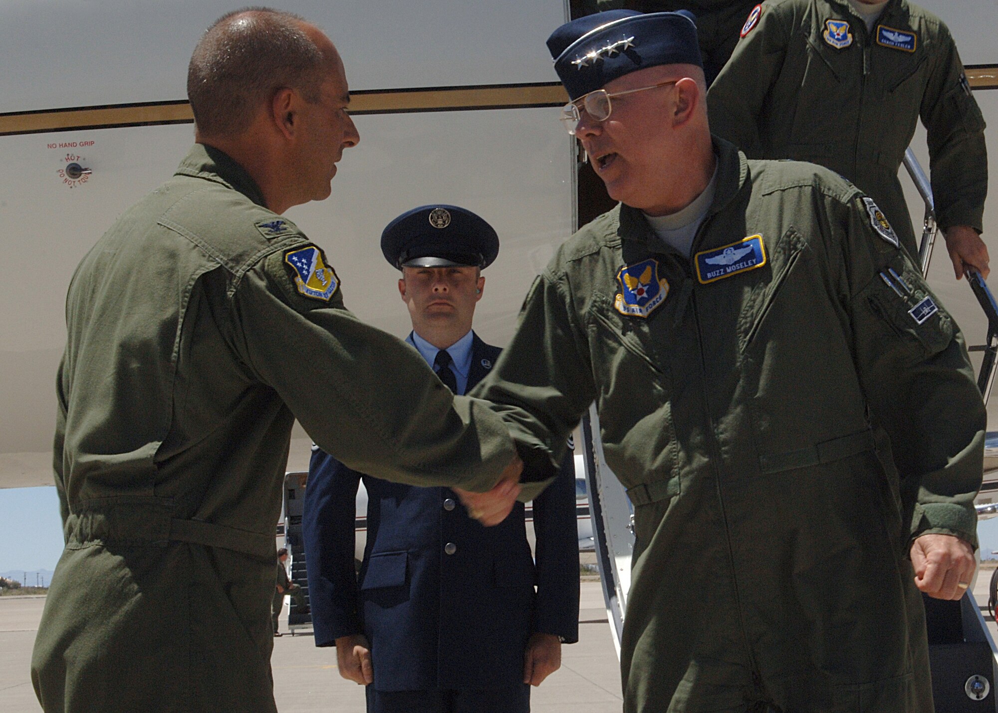 Air Force Chief of Staff Gen. Michael T. Moseley shakes hands with 49th FW Commander Colonel Jeff Harrigian upon his arrival at base operations on Holloman Air Force Base, N.M., June 6.  The ceremony was the official welcome for Holloman's first two F-22's, and also announced the Air Force Reserve's 301st Fighter Squadron from Luke Air Force Base, Ariz., will form a classic associate unit with the 7th and 8th Fighter Squadrons here.  (U.S. Air Force photo/Airman 1st Class John Strong) 
  