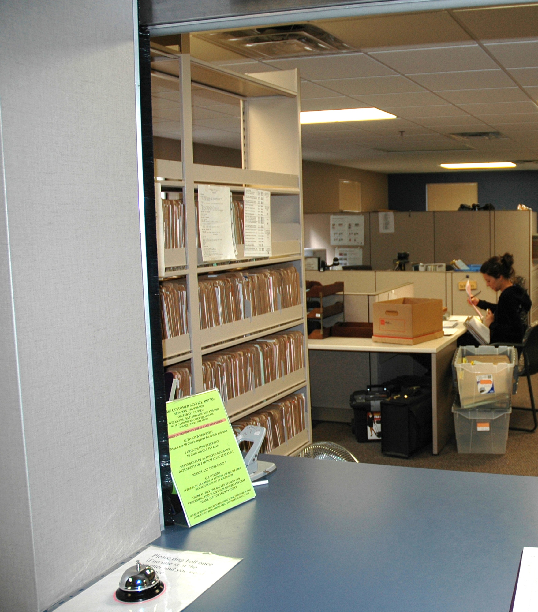 Amanda Goyen, a customer service student hire at the 446th Mission Support Group, organizes personnel records in the customer service section of the 446th Mission Support Squadron's military personnel flight.  All customer support services, such as those provided by the MPF, will no longer be available on the alternate UTA weekend, also known as the B UTA, effective Oct. 1. (U.S. Air Force photo/Tech. Sgt. Jake Chappelle)