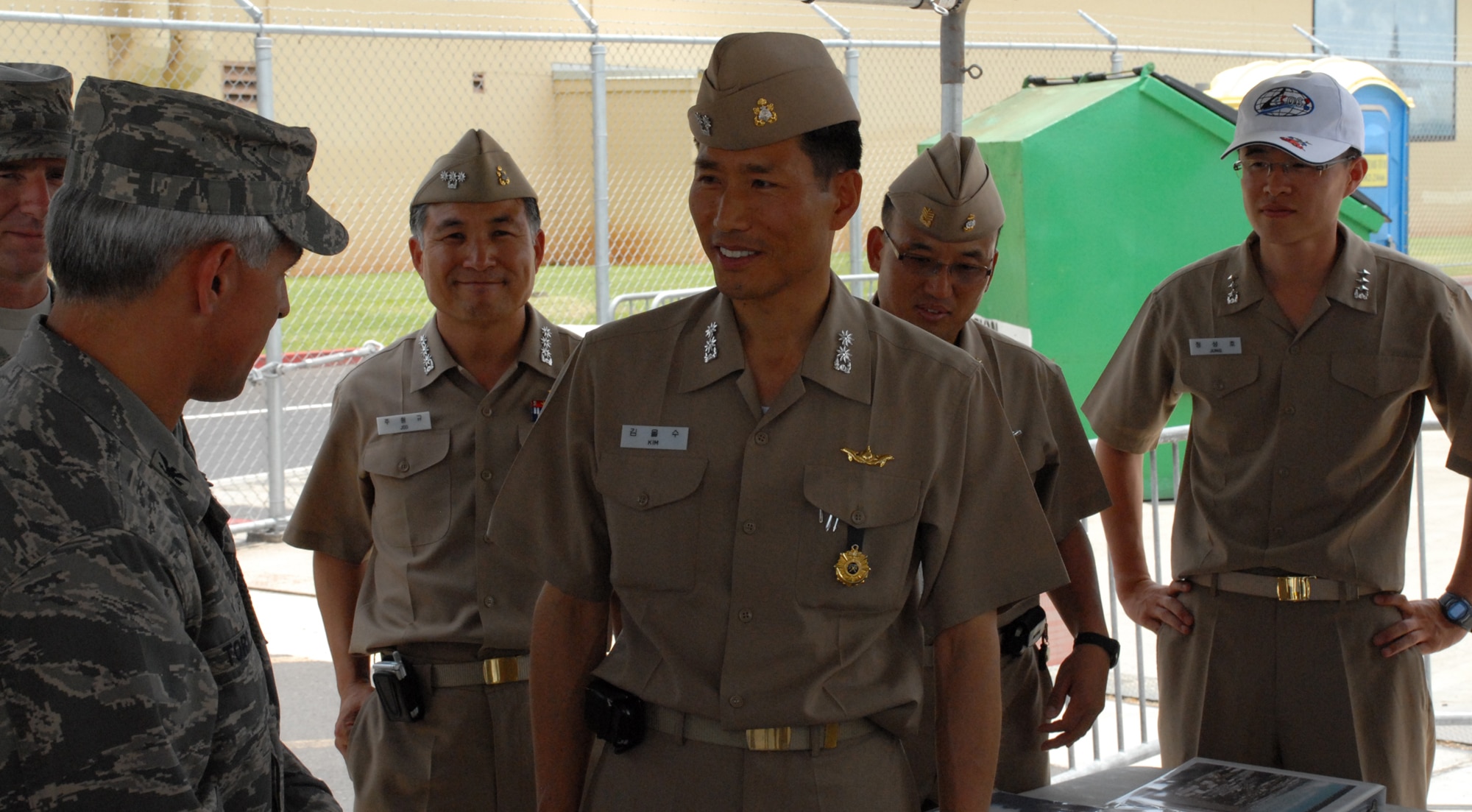 PEARL HARBOR — Colonel J.J. Torres, 15th Airlift Wing commander (left) and Navy Capt. Joo, (middle) Republic of Korea Defense Attaché to Hawaii and ROK Navy staff in the background exchange words about SS-068 and its visit to Pearl Harbor for RIMPAC, June 4.  RIMPAC is one of the largest naval exercises in the world and is designed to enhance the tactical capabilities and cooperation of participating nations in various aspects of maritime operations at sea.  The Republic of Korea (ROK) Navy is one of the participant countries.  (U.S. Air Force Photo/Staff Sgt. Erin Smith)