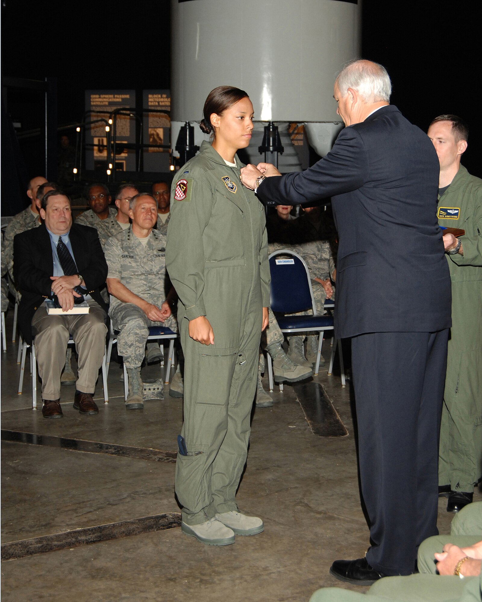 First Lt. Jennifer Jones receives her missile badge from Air Force Secretary Michael Wynne. Lieutenant Jones is assigned to the 91st Space Wing at Minot Air Force Base, N.D. She received her missile badge during a Peacekeeper Missile dedication ceremony June 6 at the National Museum of the United States Air Force. (U.S. Air Force photo/Ben Strasser)