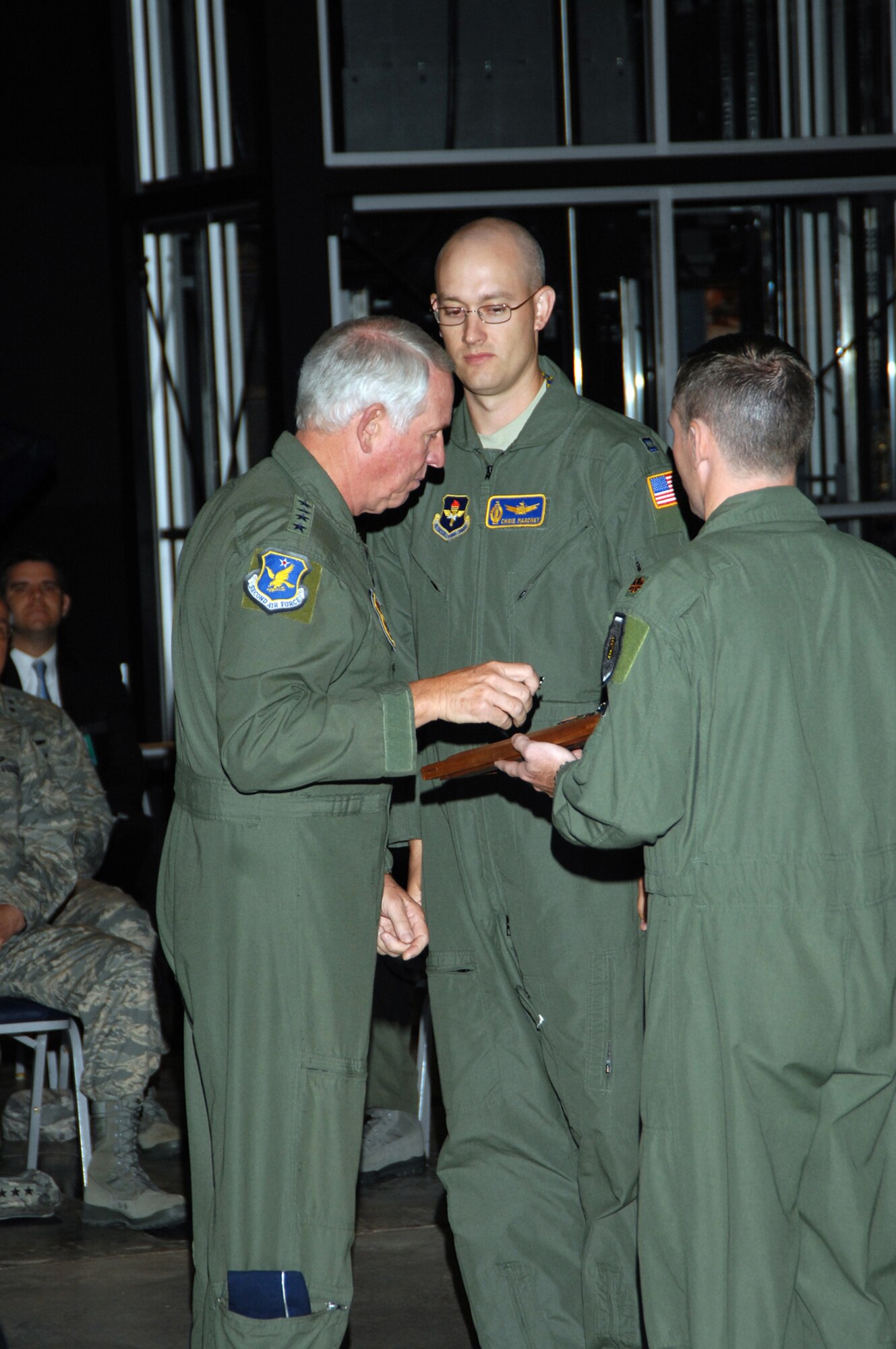 Gen. William Looney III, commander of Air Education and Training Command (left), presents a missile badge to Capt. Chris Maroney. The captain is assigned to the 392nd Training Squadron at Vandenberg Air Force Base, Calif. He received his missile badge during a Peacekeeper Missile dedication ceremony June 6 at the National Museum of the United States Air Force. (U.S. Air Force photo/Ben Strasser)