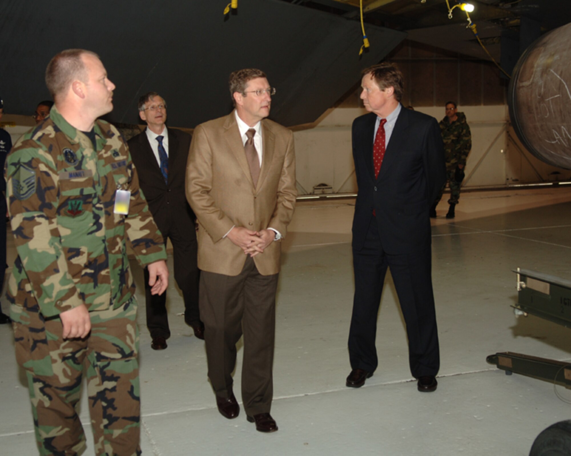 MINOT AIR FORCE BASE, N.D. -- Master Sgt. Robert Manatt, 5th Maintenance Squadron inspection section chief, briefs N.D. Senator Kent Conrad and N.D. Rep. Earl Pomeroy during a B-52 tour here June 6. The tour was in preparation for a town meeting to discuss future plans for the B-52. (U.S. Air Force photo by Airman 1st Class Sharida Bishop)
