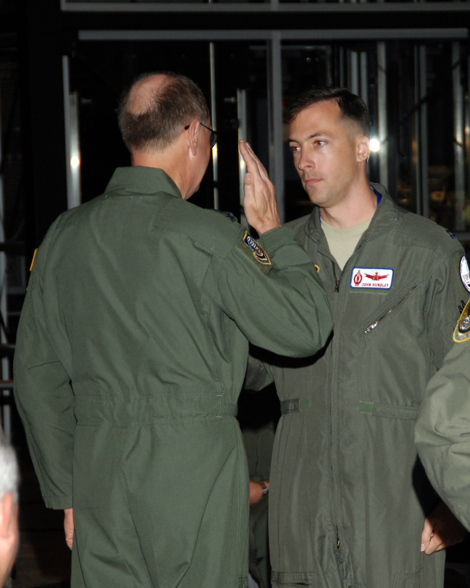Capt. John Hundley receives his missile badge from Gen. Robert Kehler, commander of Air Force Space Command. Captain Hundley is assigned to the 576th Flight Test Squadron at Vandenberg Air Force Base, Calif.  He received the badge during the Peacekeeper Missile dedication ceremony June 6 at the National Museum of the United States Air Force. (U.S. Air Force photo/Ben Strasser)