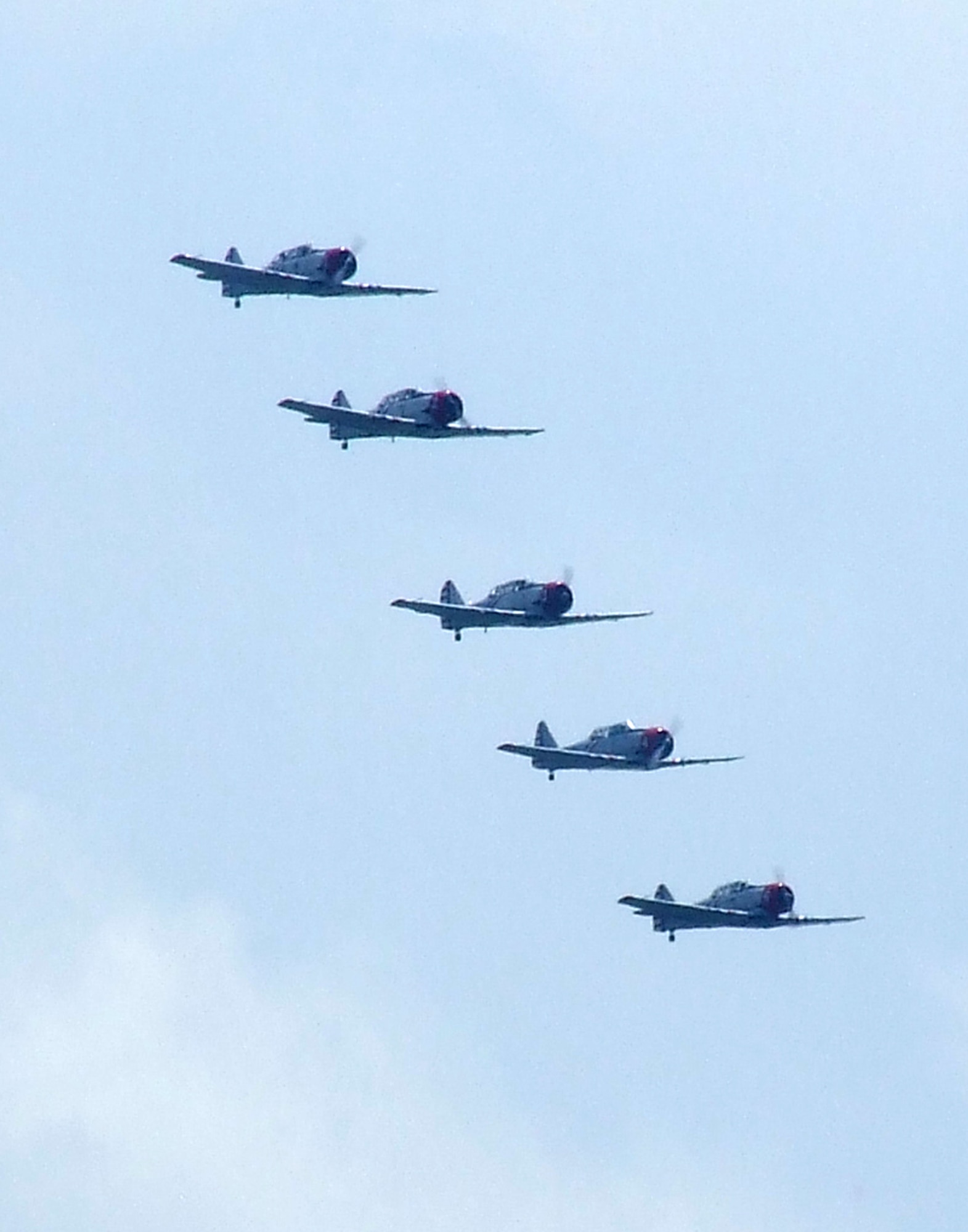 The Geico "Skywriters" fly World War II era aircraft in a formation during an aerial demonstration over McGuire Air Force Base, N.J., for the McGuire Air Expo June 1, 2008.  (U.S. Air Force Photo/Tech. Sgt. Scott T. Sturkol)