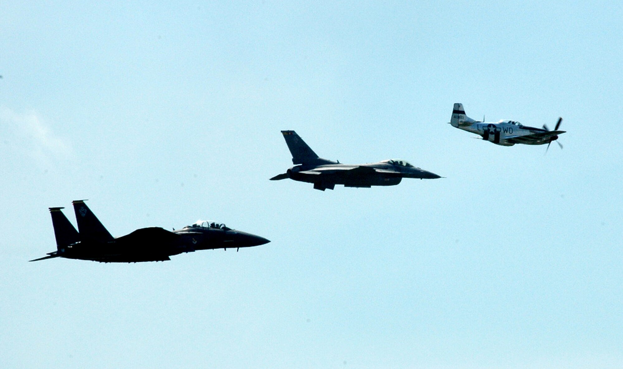 An F-15 Eagle, F-16 Fighting Falcon and P-51 Mustang fly over the airfield at McGuire Air Force Base, N.J., during the McGuire Air Expo 2008 June 1.  More than 170,000 people attended the Air Expo.  (U.S. Air Force Photo/Tech. Sgt. Scott T. Sturkol)