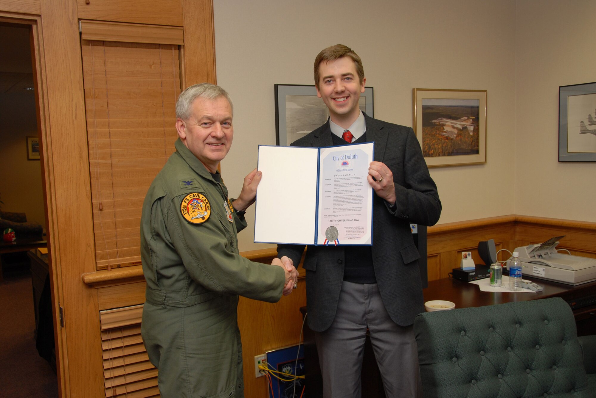 Duluth Mayor, Don Ness presented 148th Fighter Wing Commander, Col. Mark Johnson with a proclamation making February 4, 2008 “148th Fighter Wing Day” in the city of Duluth.  The proclamation states “the 148th Fighter Wing has a long history of excellence in the national service and in the defense of the United States of America” and “We wish to honor the members of the 148th Fighter Wing for their devotion, dedication to duty and the vital role they play both in the vitality of Duluth as well as the security of our nation”.