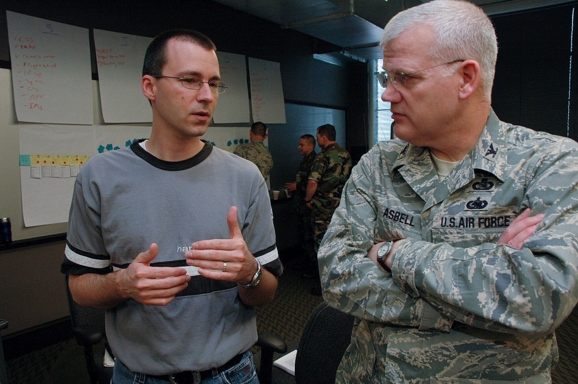 Steve Nelson talks with Col. Billy Asbell May 7 at Harley-Davidson University in Milwaukee. Air National Guard and Harley-Davidson personnel gathered for the Air Force Smart Operations for the 21st century facilitator training: Training the trainers course on process improvement. Mr. Nelson is the Harley-Davidson's process lead for operational excellence. Colonel Asbell is the director of the Air National Guard's AFSO 21 process improvement program. (U.S. Air Force photo/Senior Airman Nathan Wallin)  
