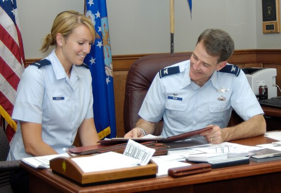 HANSCOM AFB, Mass. -- Col. Steve Webb, former 350th Electronic Systems Group commander, reviews a briefing with 1st Lt. Julienne White, the group executive officer, on a recent afternoon. Colonel Webb retired from his job at Hanscom this week after 28 years of Air Force service. His plans after retirement include spending more time with his family, home improvement projects and learning the ropes of a new job in the local area. (U.S. Air Force photo by Linda LaBonte-Britt)
