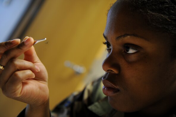 MOODY AIR FORCE BASE, Ga. -- Airman 1st Class Andrea Kearse, 23rd Aeromedical Dental Squadron public health technician, looks over a mosquito for damage and to determine it's sex here June 6. Only female mosquitoes can be sent to a testing facility in Texas where they will be tested for diseases. (U.S. Air Force photo by Senior Airman Gina Chiaverotti) 
