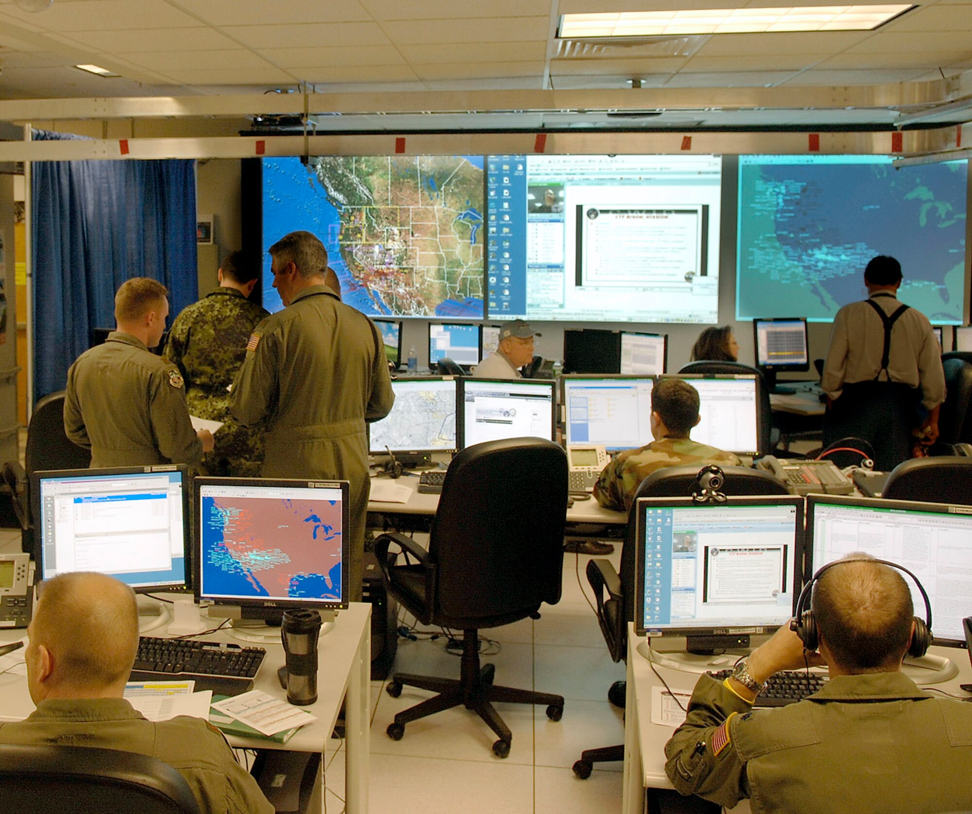 Air Force active-duty, Guard and Reserve members participating in the 2007 Coalition Warrior Interoperability Demonstration join coalition forces on the floor of a mock Combined Air Operations Center in June 2007 at Hanscom Air Force Base, Mass. Participants are now gathering to set up at the Hanscom AFB site, as well as at many other sites around the globe, to prepare for this year's demonstration, which kicks off June 9. (U.S. Air Force photo/Jan Abate)