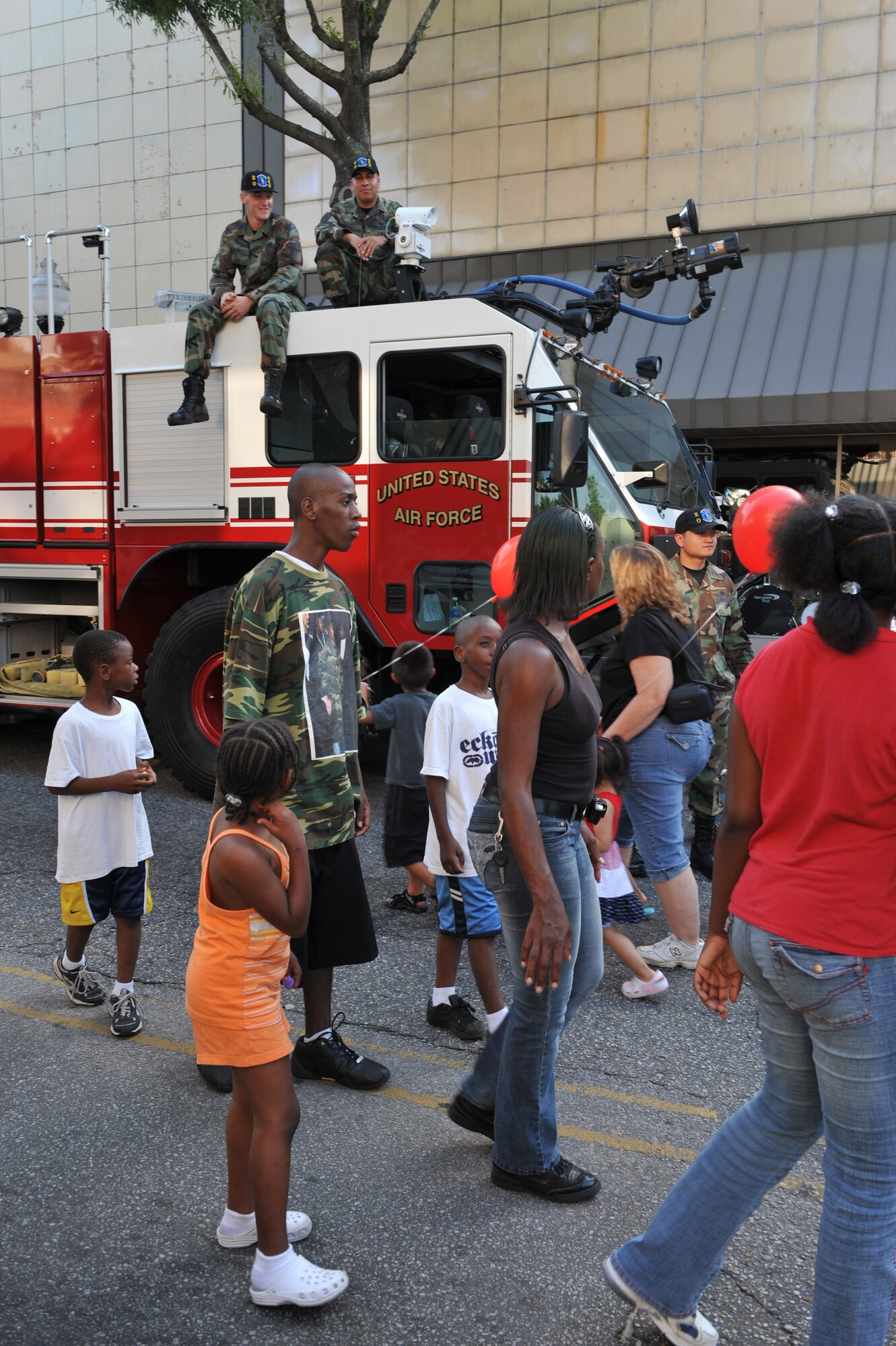 SUMTER, S.C. -- Airman 1st Class John Neidrick, Senior Airman Randy Torres and Senior Airman Raymond Drury, 20th Civil Engineer Squadron Fire Fighters, mingle with the crowd at the seventh annual Sumter-Shaw Street Fest in down town Sumter May 30. The festival gives Shaw members the opportunity to interact with the local community and educate them about Shaw's mission. (U.S. Air Force photo by: TSgt Josef E. Cole III)