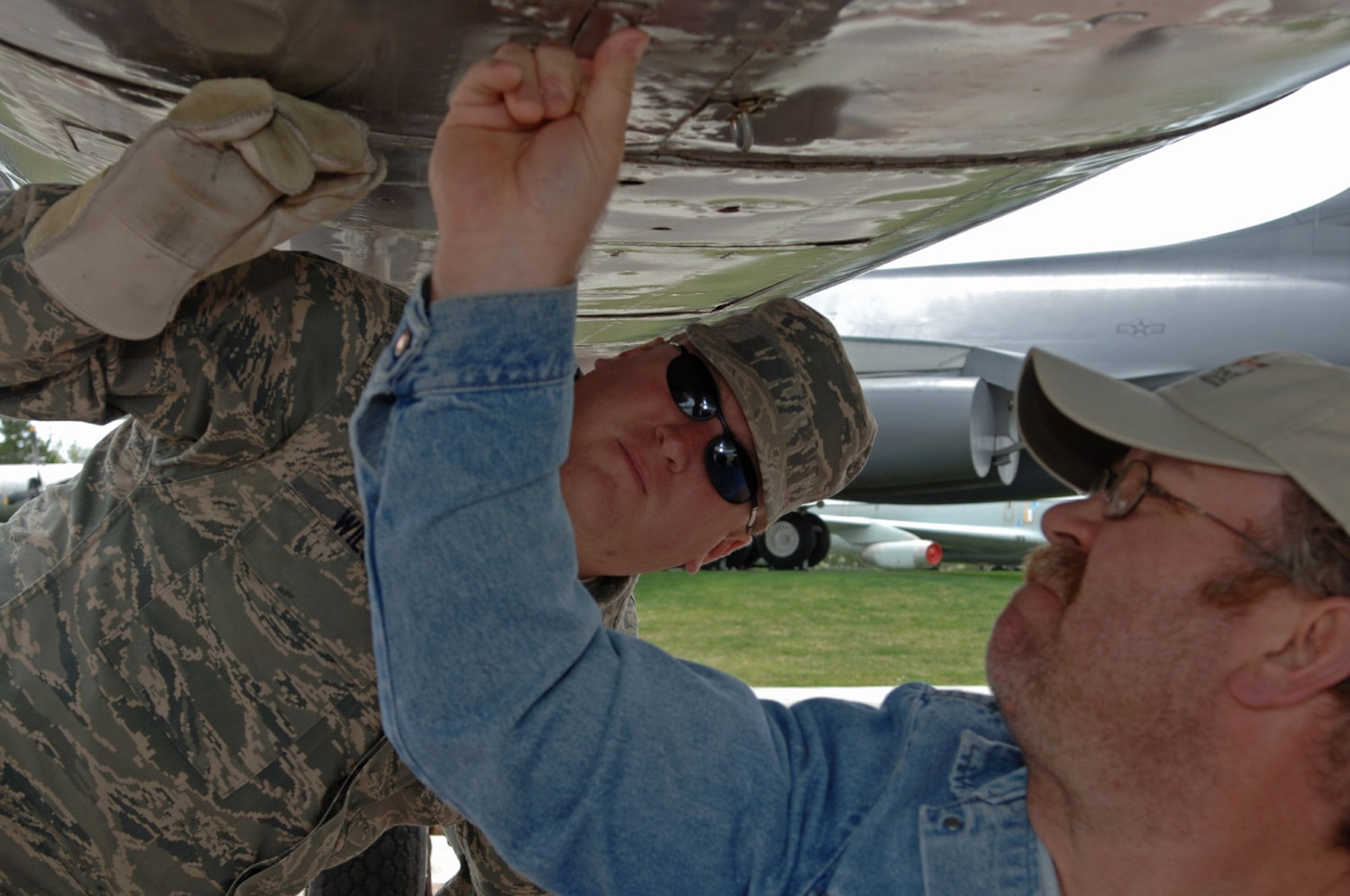 (Left) Tech. Sgt. Steven Wilson, South Dakota Air and Space Museum director, and Joe Drab Jr., Ellsworth Heritage Program board member, open Gen. Dwight D. Eisenhower's North American B-25 Mitchell personal transport at the museum May 21, 2008. The plane was used as General Eisenhowers personal transport during World War II and may have been used during D-Day. (U.S. Air Force photo/Airman Corey Hook)