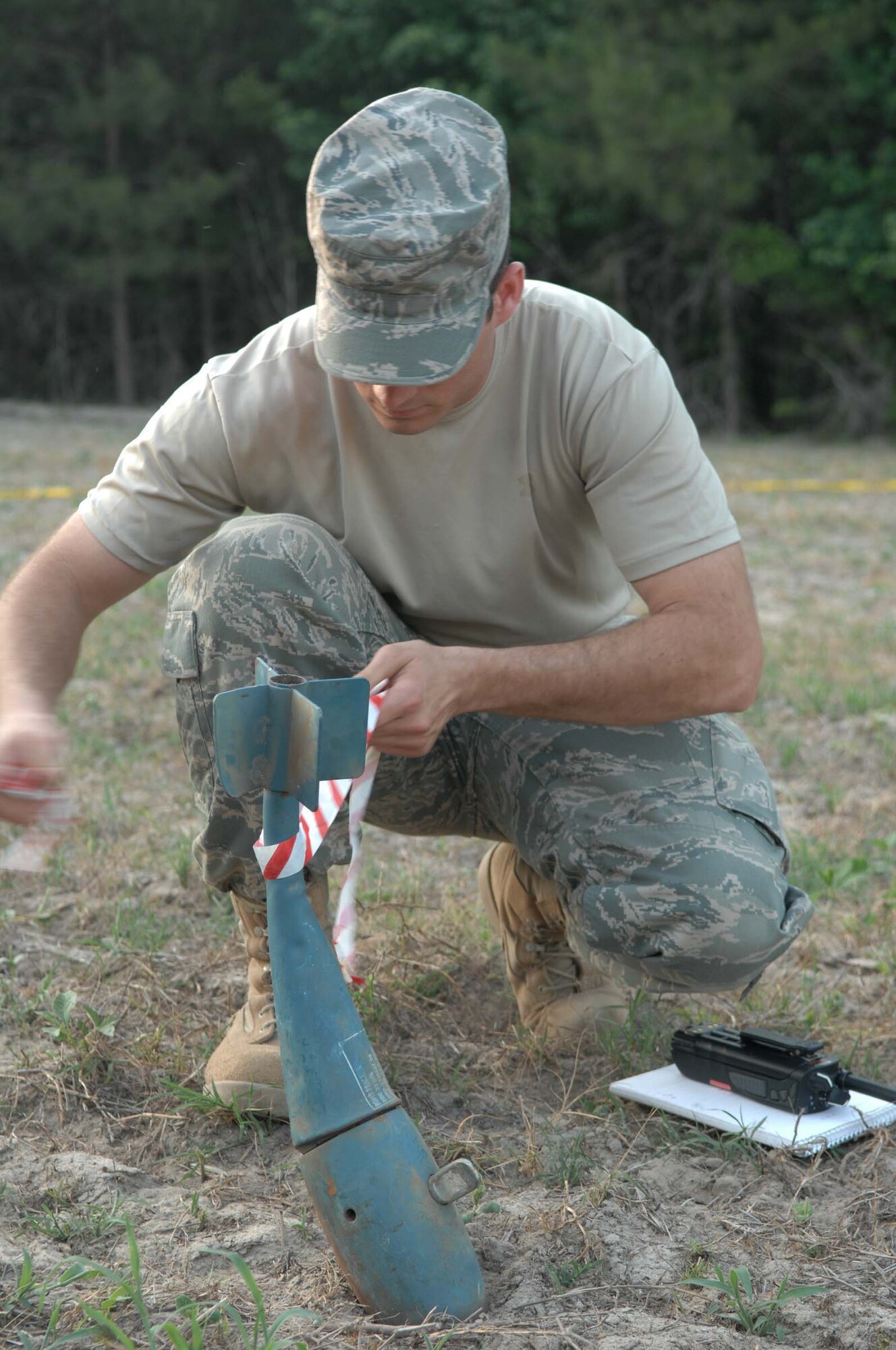 SHAW AIR FORCE BASE, S.C. -- Staff Sgt. Michael Konyu, 20th Civil Engineer Squadron explosive ordnance disposal specialist, marks a munition for a simulated F-16 crash during a major accident response exercise June 6. The MARE prepares Airmen and emergency responders from Shaw AFB on different scenarios for real world operations. (U.S. Air Force photo/Airman 1st Class Matthew Davis)