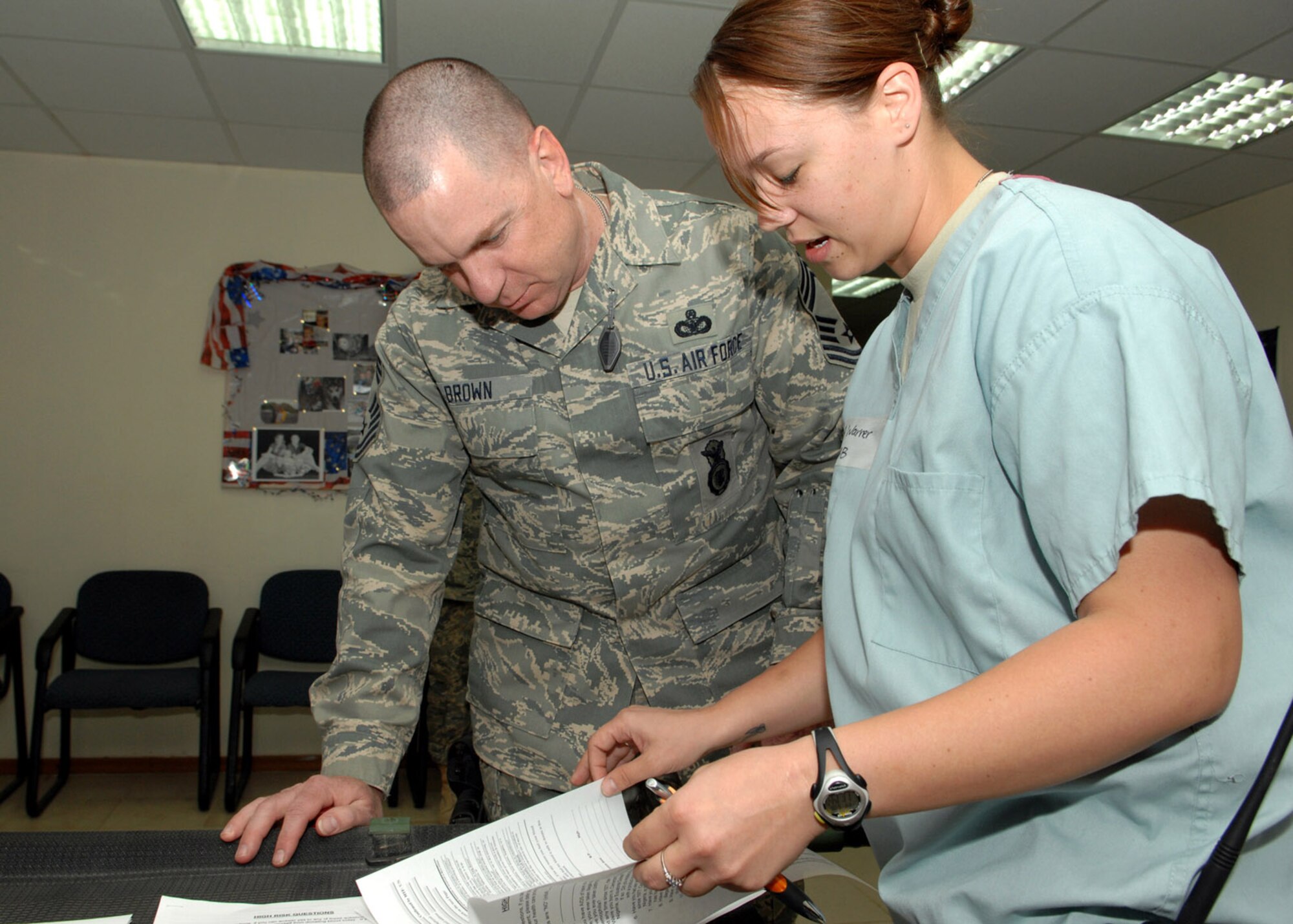 KIRKUK REGIONAL AIR BASE, Iraq – Chief Master Sgt. Gary Brown, 506th Air Expeditionary Group superintendent, takes part in a blood donation prescreening administered by Senior Airman Tami Warner, 506th Expeditionary Medical Squadron, July 6 here. The prescreening involves initial paperwork before blood is drawn. A tube is then used for blood type confirmation and bio-screening. Afterwards, a prescreening list pool is formed and notification is sent to the donor. The prescreening allows preparation for emergency blood donations. It also cuts down on time to get blood from donors to the operation room. Airman Warner is a medical laboratory journeyman deployed here from Eglin Air Force Base, Fla., and is a native of South Bridge, Mass. (U.S. Air Force photo by Senior Airman SerMae Lampkin)